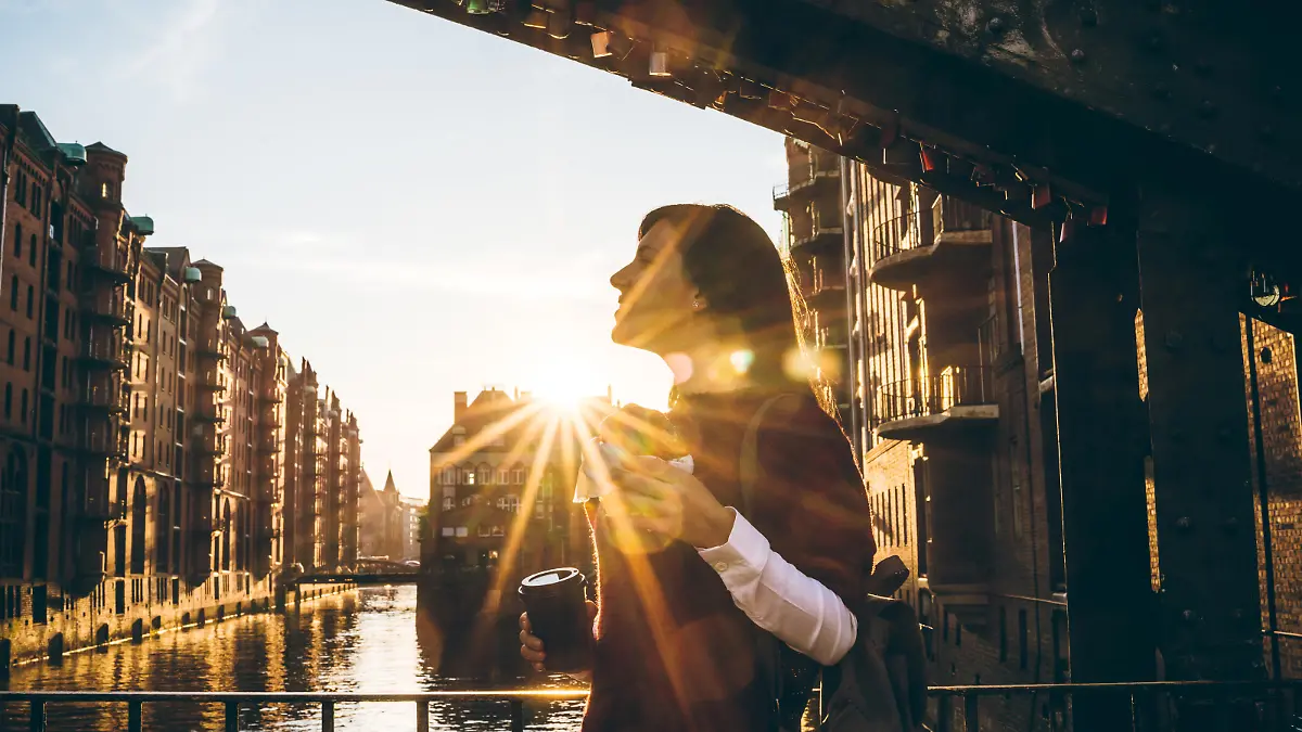 Young tourist woman is exploring Speicherstadt, old part of Hamburg, Germany