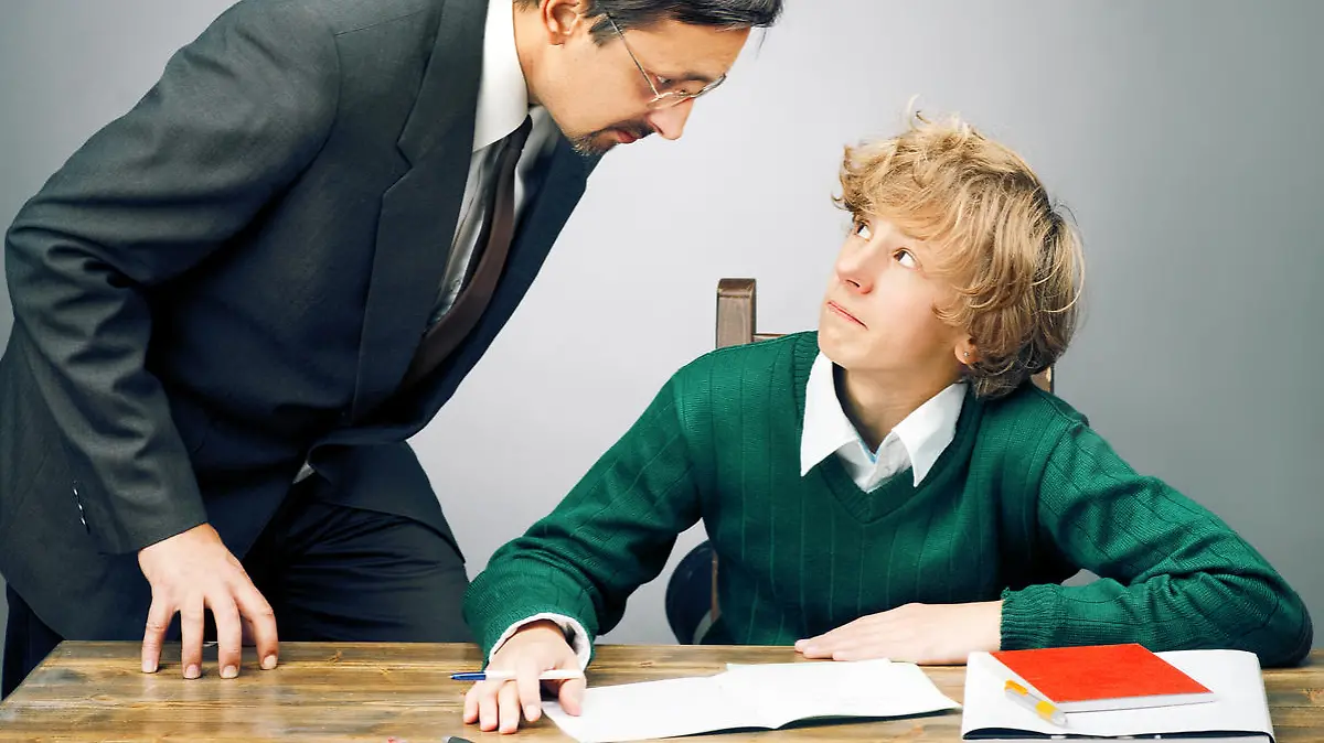 Angry teacher with schoolboy