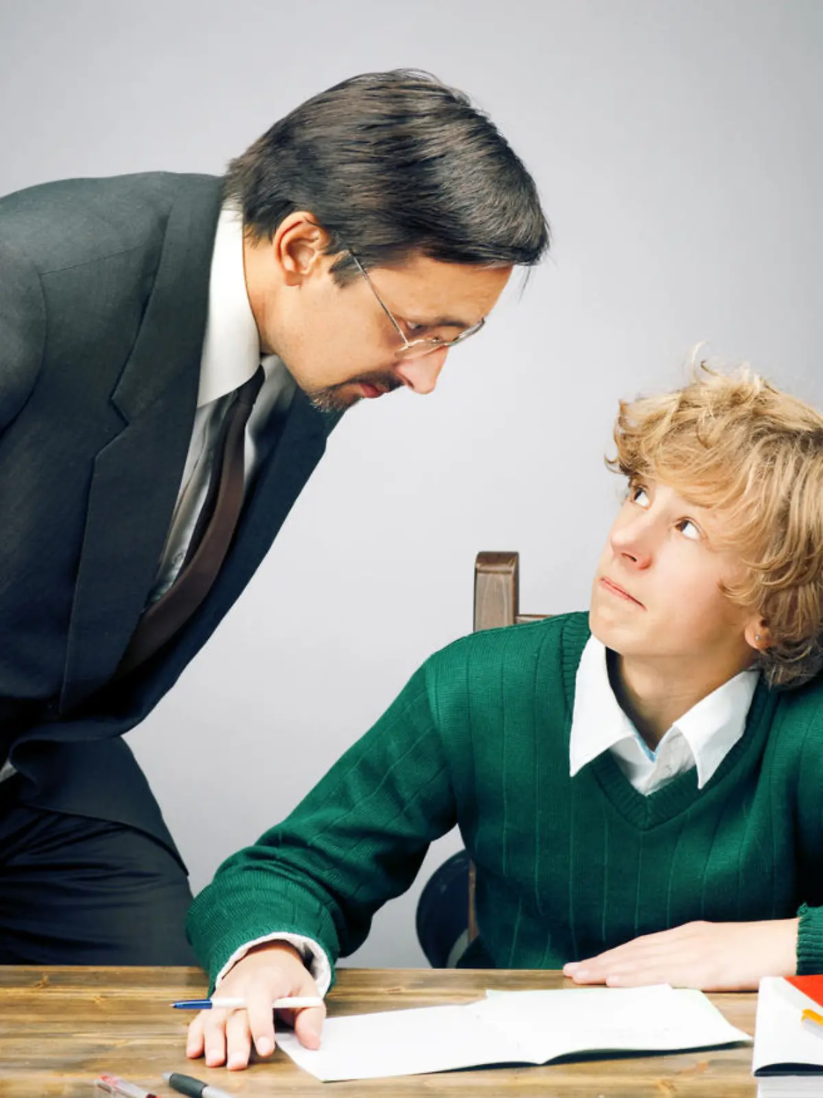 Angry teacher with schoolboy