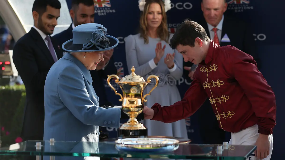 QIPCO British Champions Day - Ascot Races. Queen Elizabeth II presents Oisin Murphy with his trophy after Roaring Lion won The Queen Elizabeth II Stakes Race run during QIPCO British Champions Day at Ascot Racecourse. Picture date: Saturday October 20, 2018. See PA story RACING Ascot. Photo credit should read: Julian Herbert/PA Wire. RESTRICTIONS: Use subject to restrictions. Editorial use only, no commercial or promotional use. No private sales. URN:39226709