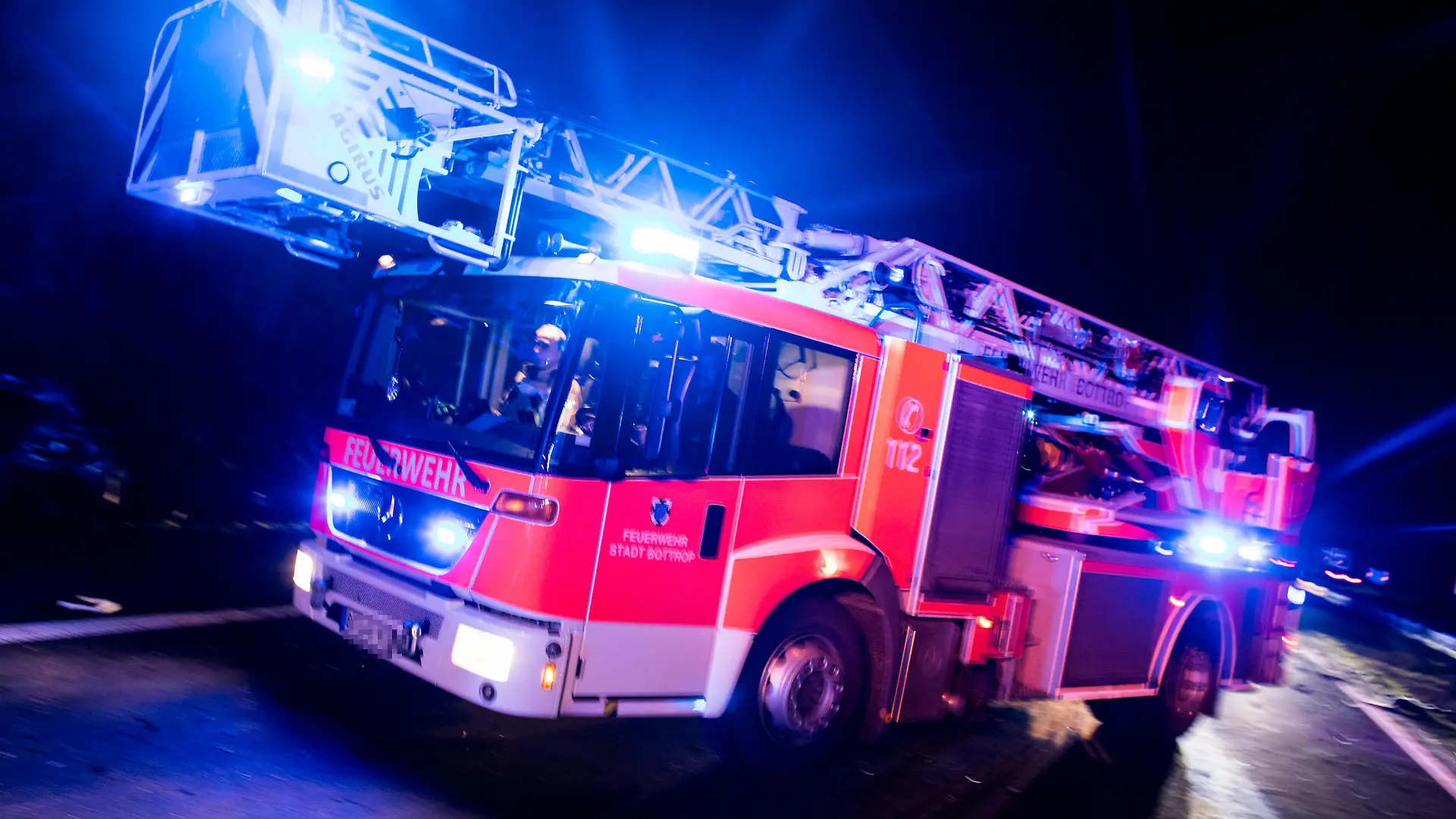 ARCHIV - ILLUSTRATION - Ein Drehleiterwagen der Feuerwehr fährt am 21.01.2018 in Bottrop (Nordrhein-Westfalen) mit Blaulicht an einer Unfallstelle vorbei. In Münster wird am Freitag eine Studie ·Gewalt gegen Einsatzkräfte· vorgestellt. Foto: Marcel Kusch/dpa +++ dpa-Bildfunk +++