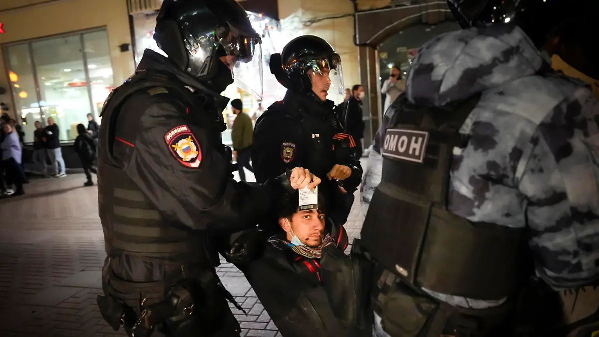 21.09.2022, Russland, Moskau: Polizisten tragen einen Demonstranten während einer Demonstration gegen die Mobilisierung weg, der einen Ausweis in der Hand hält. Bei Protesten in Russland gegen die von Kremlchef Putin angeordnete Teilmobilmachung des Militärs sind mehr als 1300 Menschen festgenommen worden. Das Bürgerrechtsportal OVD-Info zählte am Mittwochabend über 1350 Festnahmen in 38 Städten des Landes. In Moskau wurden diesen Angaben zufolge mehr als 500 Demonstranten in Gewahrsam genommen. Foto: Alexander Zemlianichenko/AP/dpa +++ dpa-Bildfunk +++