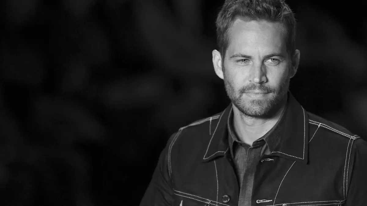 U.S. actor Paul Walker presents a creation from Colcci's 2013/2014 summer collection during Sao Paulo Fashion Week in this March 21, 2013, file photo. No drugs or alcohol were found in the bodies of "Fast & Furious" actor Walker and his friend Roger Rodas after the fiery car crash that killed them in November, a coroner's report released on January 3, 2014, said. REUTERS/Filipe Carvalho/Files (BRAZIL - Tags: FASHION ENTERTAINMENT)