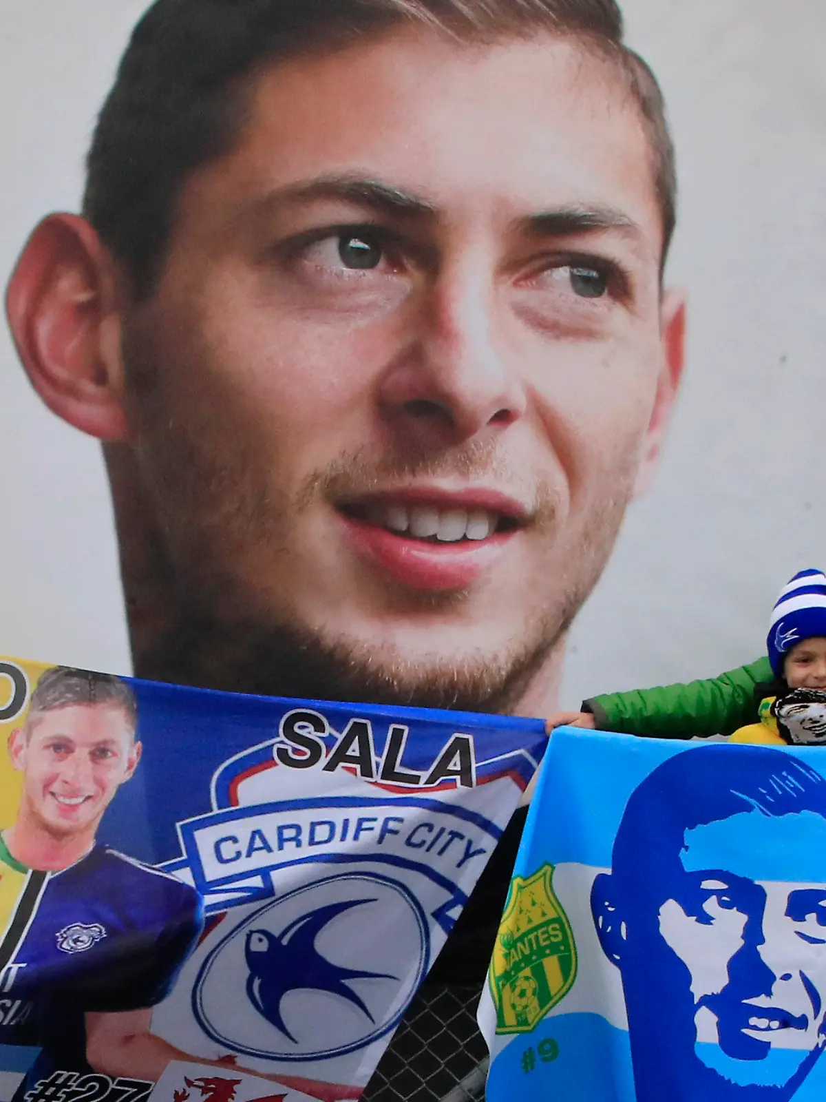 FILE - Cardiff supporters gather to pay tribute to Argentinian soccer player Emiliano Sala prior the French League One soccer match between Nantes against Bordeaux at La Beaujoire stadium in Nantes, western France, on Jan. 26, 2020. A years-long transfer dispute after the death in an airplane crash of soccer player Emiliano Sala was settled on Friday Aug. 26, 2022 in favor of his former club Nantes against Cardiff. (AP Photo/Michel Euler, File)