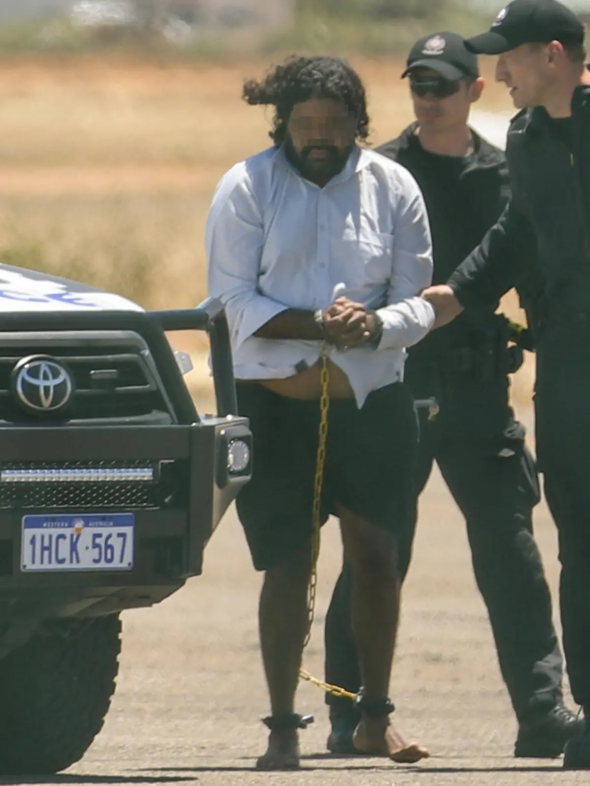 CARNARVON , AUSTRALIA - NOVEMBER 5: Terence Darrell Kelly boards a plane after being taken into custody by members of the Special Operations Group at Carnarvon airport on November 5, 2021 in Carnarvon , Australia. Kelly, 36, has been charged with various offences relating to the disappearance of Cleo Smith, 4, who was abducted from a campsite in the Gascoyne region on October 16th and found alive on November 3rd. He is being transported to Perth and will re-appear in court In December. (Photo by Tamati Smith/Getty Images)