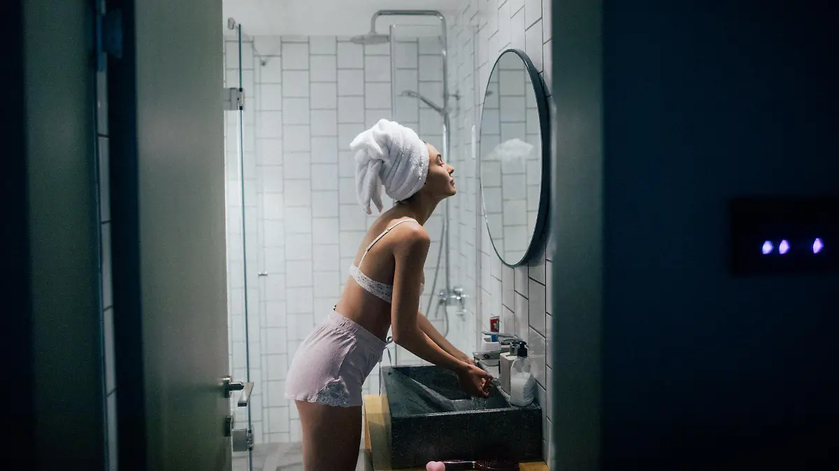 Young woman in the bathroom with her towel on