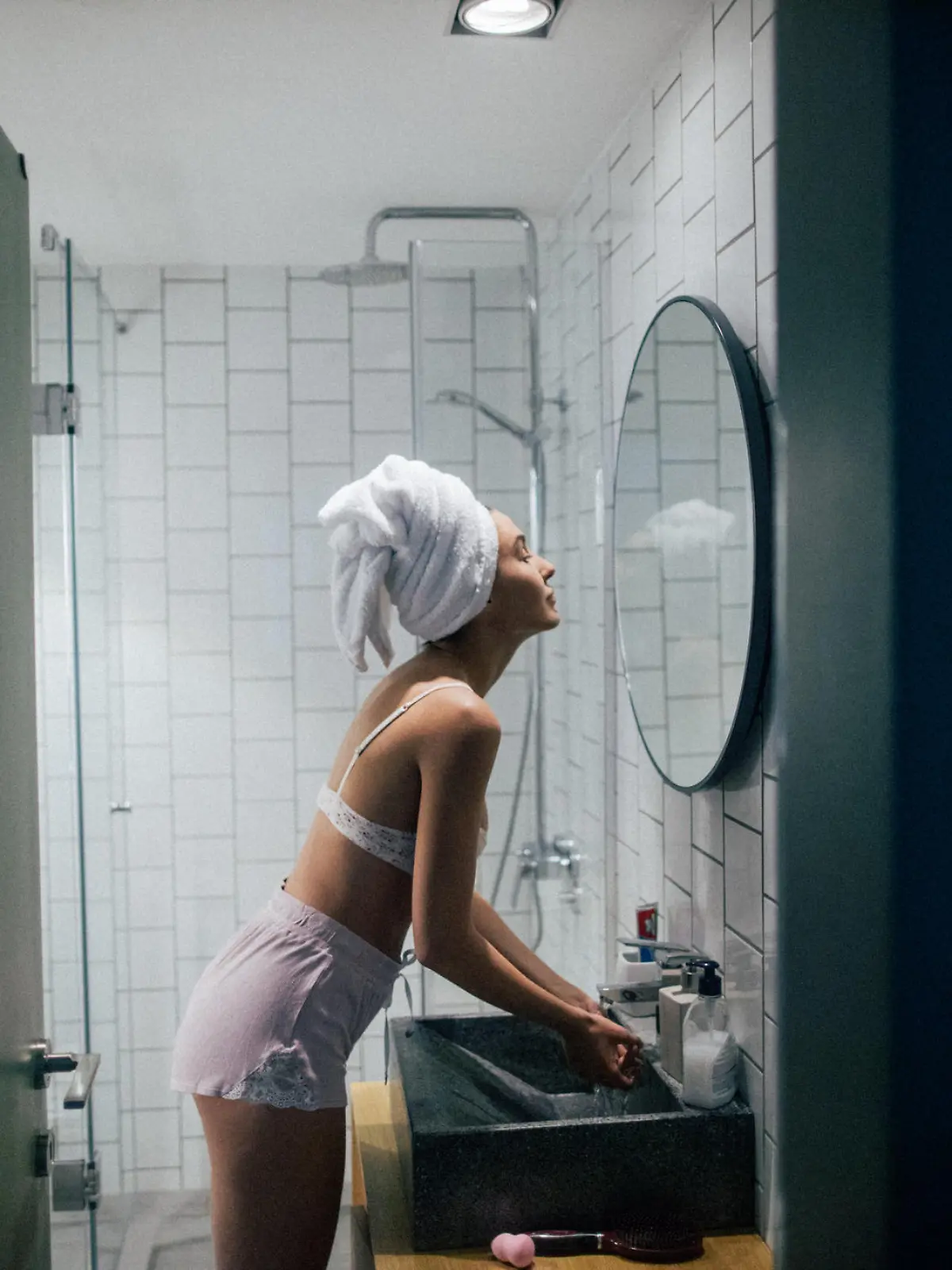 Young woman in the bathroom with her towel on