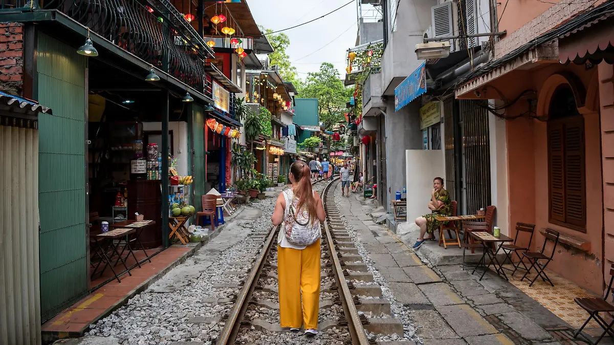 Hanoi, Hanoi, Vietnam; 06-06-2022. Young person touring tourist places in Hanoi, Vietnam. Tourist walking along Train Street in Hanoi, Vietnam