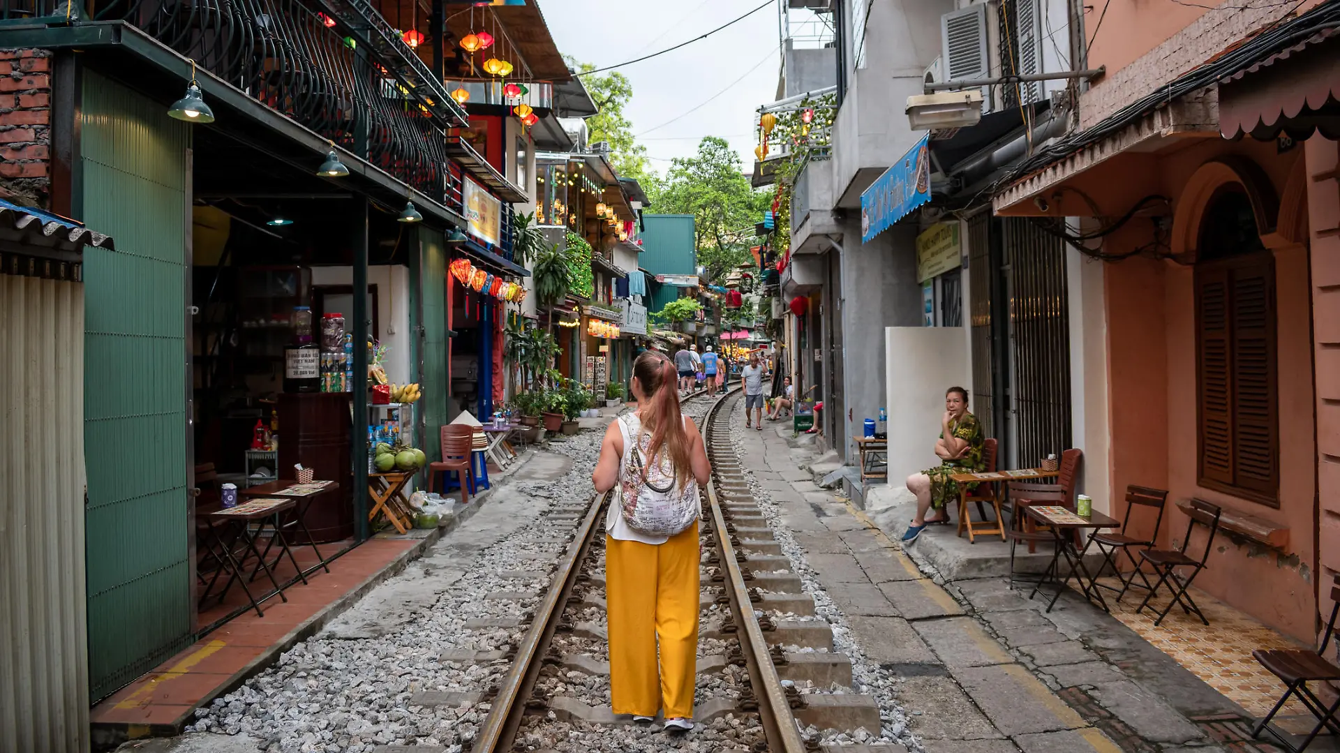 Hanoi, Hanoi, Vietnam; 06-06-2022. Young person touring tourist places in Hanoi, Vietnam. Tourist walking along Train Street in Hanoi, Vietnam