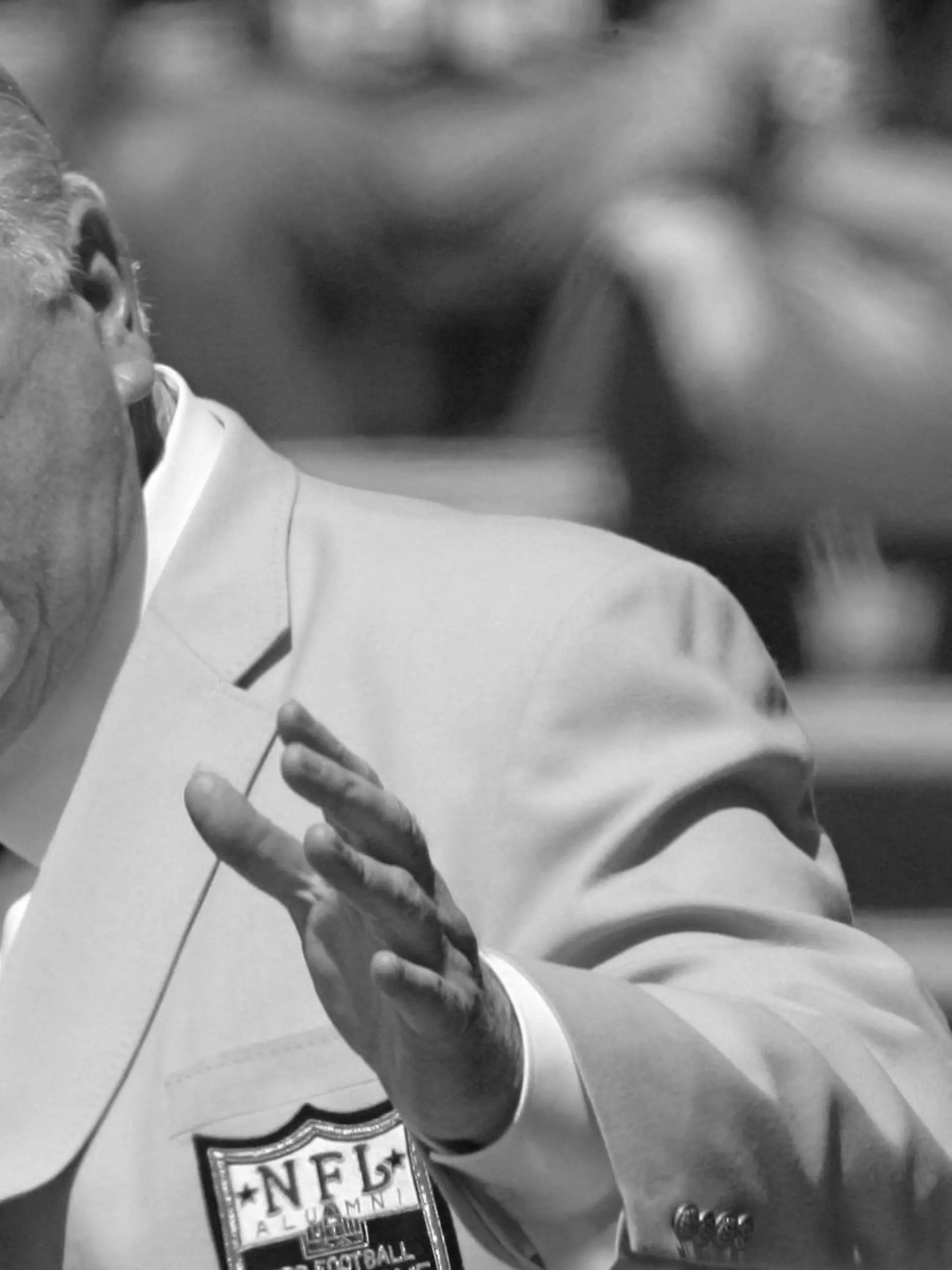 ARCHIV - 05.08.2006, USA, Canton: John Madden, ehemaliger Trainer der Oakland Raiders, gestikuliert während seiner Aufnahme in die Pro Football Hall of Fame in Canton, Ohio, in Richtung einer Büste von ihm. Die Football-Welt trauert um John Madden. Die Trainer- und Kommentatorenlegende ist am Dienstag, 28.12.2021, im Alter von 85 Jahren gestorben. Foto: Mark Duncan/AP/dpa +++ dpa-Bildfunk +++