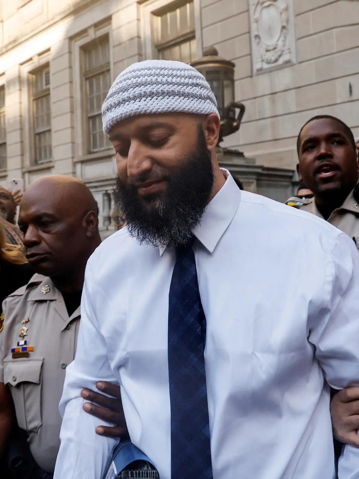 Adnan Syed, whose case was chronicled in the hit podcast "Serial," departs after a judge overturned Syed's 2000 murder conviction and ordered a new trial during a hearing at the Baltimore City Circuit Courthouse in Baltimore, Maryland, U.S., September 19, 2022. REUTERS/Jonathan Ernst    TPX IMAGES OF THE DAY