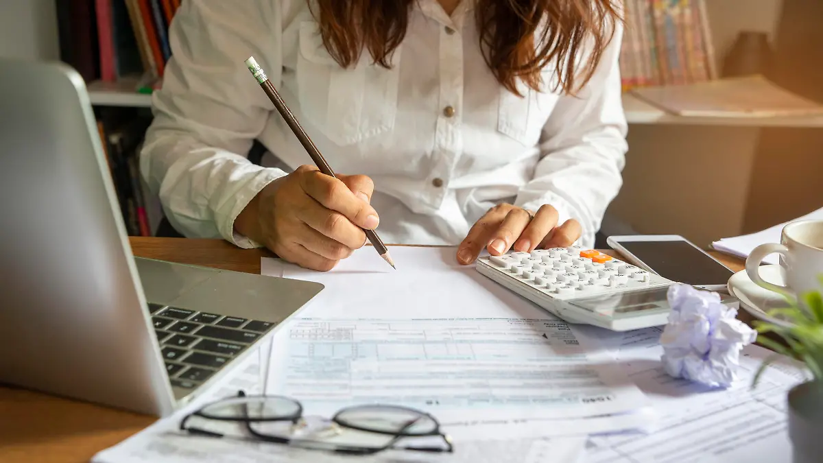 Budget planning concept,Accountant is calculating company's annual tax.Calendar 2019 and personal income tax forms for those who have income under US law placed on office desk.This is the season to pay taxes.
