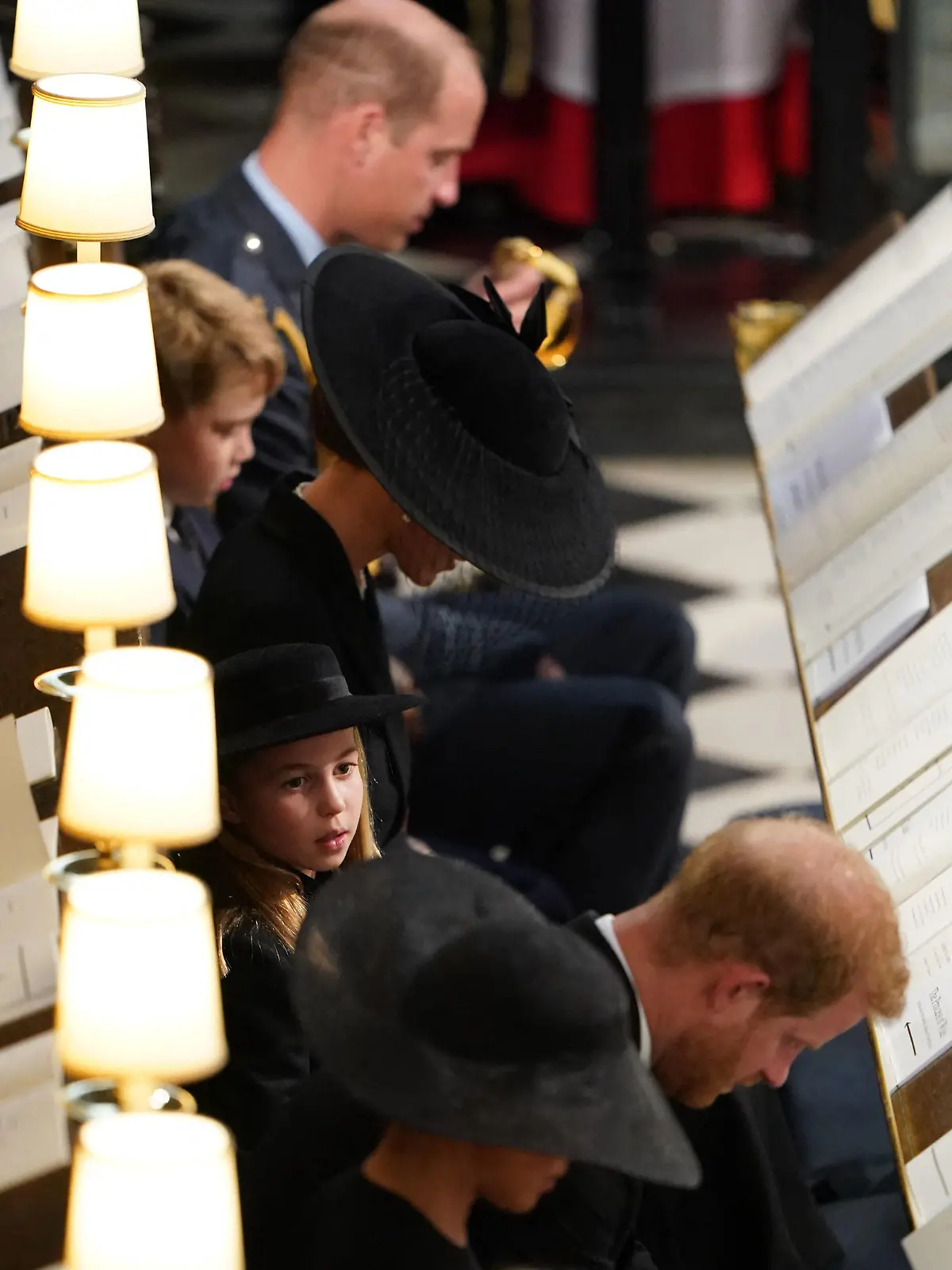 Britain's Princess Charlotte of Wales sits with Britain's Prince William, Prince of Wales, Britain's Prince George of Wales, Britain's Catherine, Princess of Wales, Britain's Prince Harry, Duke of Sussex and Meghan, Duchess of Sussex during the Committal Service for Britain's Queen Elizabeth II in St George's Chapel inside Windsor Castle on September 19, 2022. - Monday's committal service is expected to be attended by at least 800 people, most of whom will not have been at the earlier State Funeral at Westminster Abbey. (Photo by Joe Giddens / POOL / AFP) (Photo by JOE GIDDENS/POOL/AFP via Getty Images)
