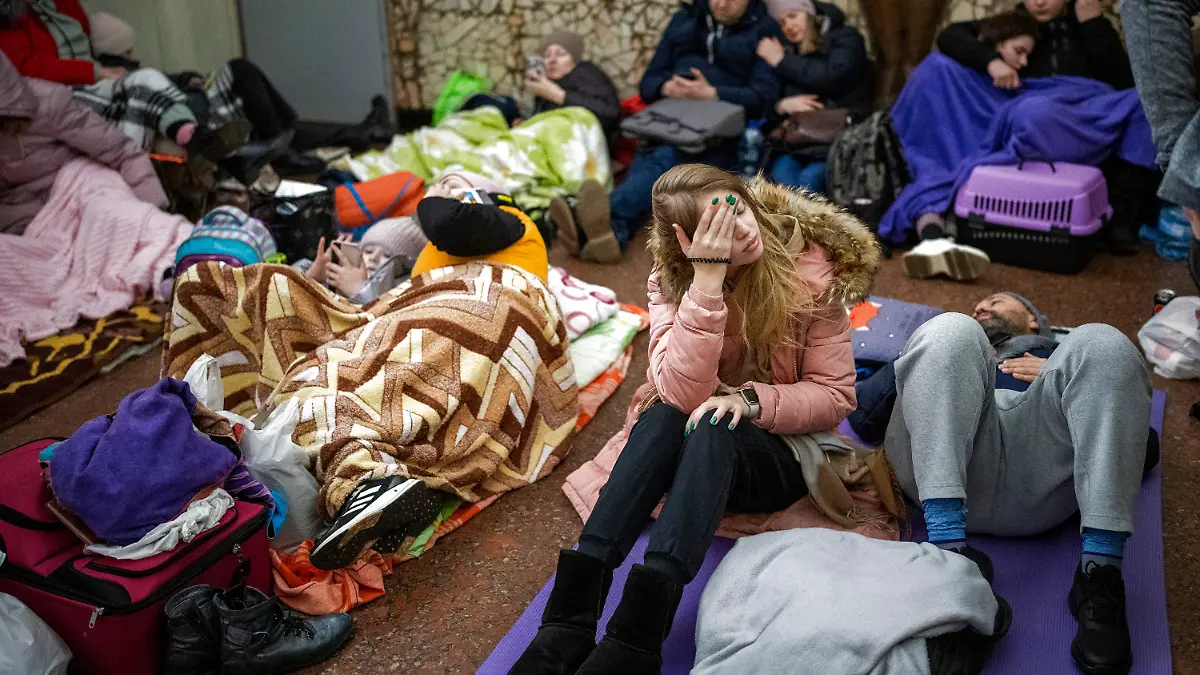 People rest in the Kyiv subway, using it as a bomb shelter in Kyiv, Ukraine, Thursday, Feb. 24, 2022. Russia has launched a full-scale invasion of Ukraine, unleashing airstrikes on cities and military bases and sending troops and tanks from multiple directions in a move that could rewrite the world's geopolitical landscape. (AP Photo/Emilio Morenatti)