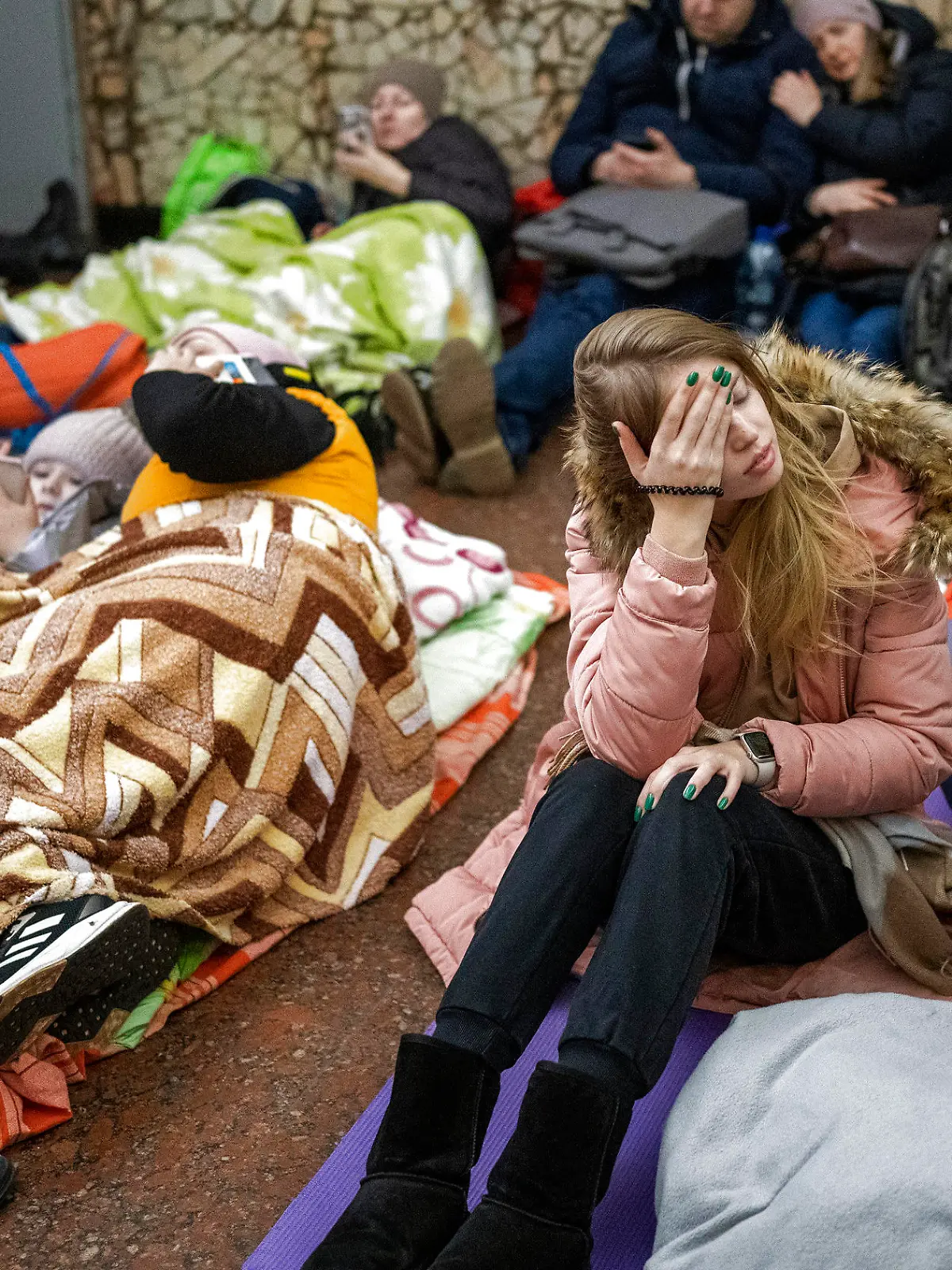 People rest in the Kyiv subway, using it as a bomb shelter in Kyiv, Ukraine, Thursday, Feb. 24, 2022. Russia has launched a full-scale invasion of Ukraine, unleashing airstrikes on cities and military bases and sending troops and tanks from multiple directions in a move that could rewrite the world's geopolitical landscape. (AP Photo/Emilio Morenatti)