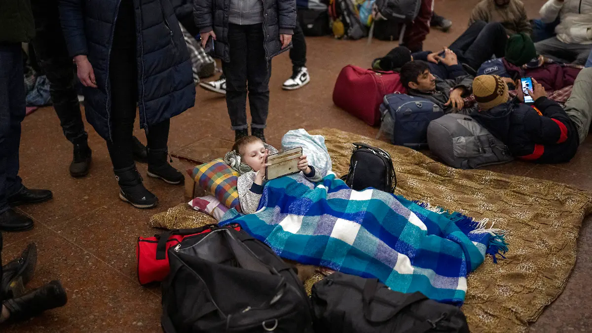 People rest in the Kyiv subway, using it as a bomb shelter in Kyiv, Ukraine, Thursday, Feb. 24, 2022. Russia has launched a full-scale invasion of Ukraine, unleashing airstrikes on cities and military bases and sending troops and tanks from multiple directions in a move that could rewrite the world's geopolitical landscape. (AP Photo/Emilio Morenatti)