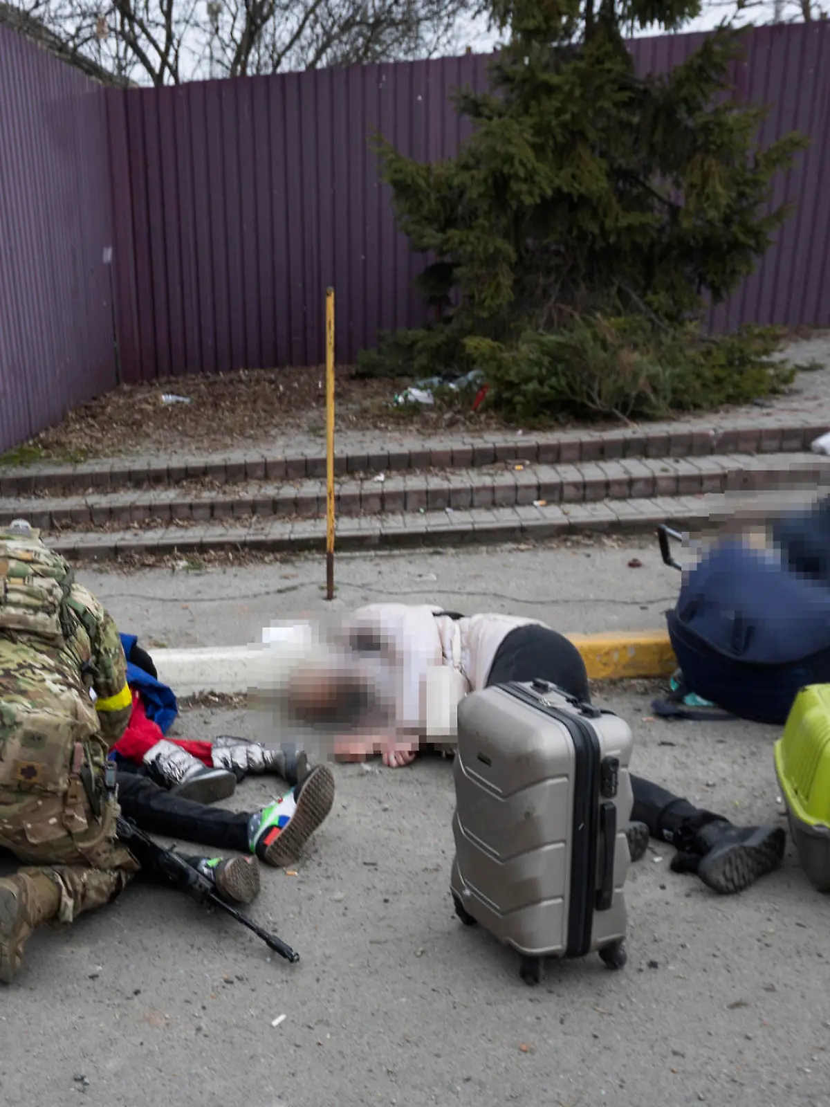 Ukrainian servicemen try to help people wounded, in the town of Irpin, Ukraine, Sunday, March 6, 2022. With the Kremlin's rhetoric growing fiercer and a reprieve from fighting dissolving, Russian troops continued to shell encircled cities and the number of Ukrainians forced from their country grew to over 1.4 million. (AP Photo/Andriy Dubchak)