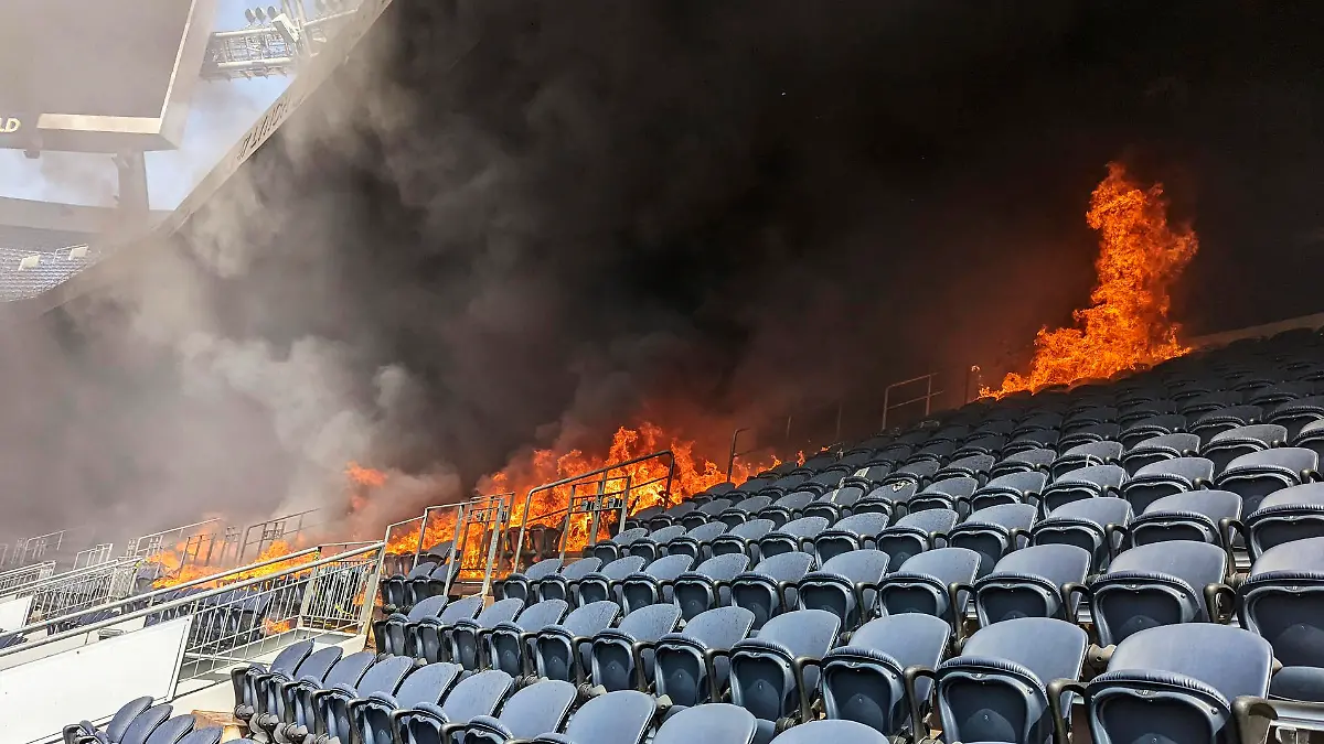 In this photo provided by the Denver Fire Department, a fire burns at Empower Field at Mile High stadium in Denver, Thursday, March 24, 2022. Firefighters have extinguished a blaze that torched several rows of seats and a suite area at the Denver Broncos' stadium. The fire broke out in the third-level and burned at least six rows of seats in two sections. (Denver Fire Department via AP)