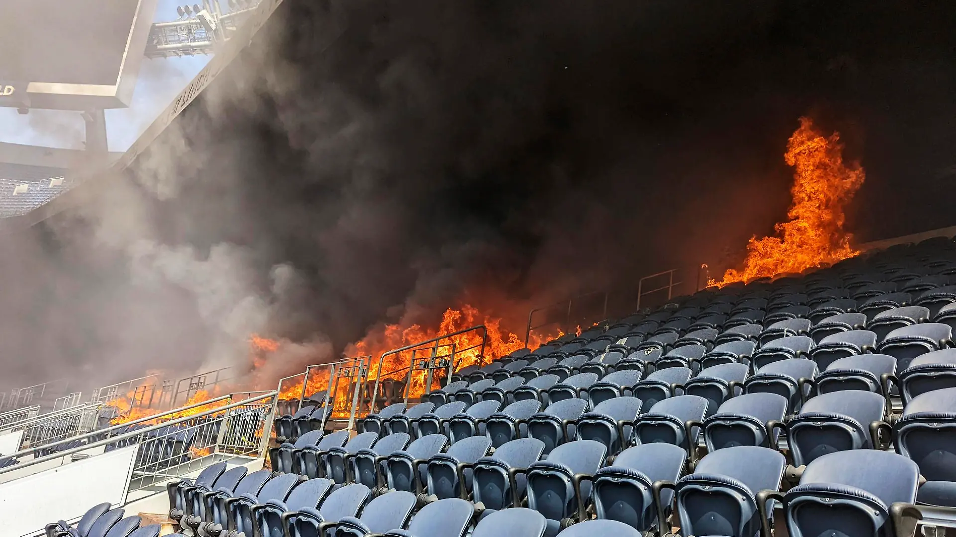 In this photo provided by the Denver Fire Department, a fire burns at Empower Field at Mile High stadium in Denver, Thursday, March 24, 2022. Firefighters have extinguished a blaze that torched several rows of seats and a suite area at the Denver Broncos' stadium. The fire broke out in the third-level and burned at least six rows of seats in two sections. (Denver Fire Department via AP)