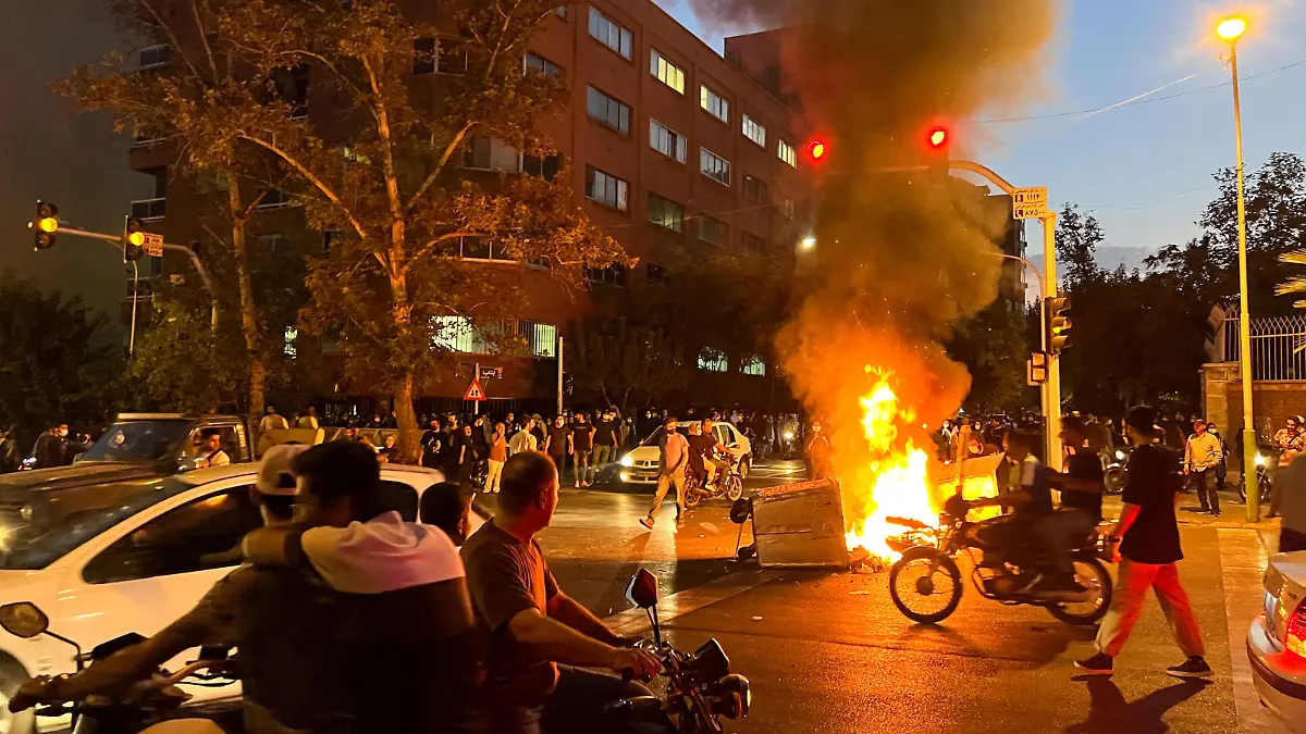 A police motorcycle burns during a protest over the death of Mahsa Amini, a woman who died after being arrested by the Islamic republic's "morality police", in Tehran, Iran September 19, 2022. WANA (West Asia News Agency) via REUTERS ATTENTION EDITORS - THIS IMAGE HAS BEEN SUPPLIED BY A THIRD PARTY.   ATTENTION EDITORS - THIS PICTURE WAS PROVIDED BY A THIRD PARTY