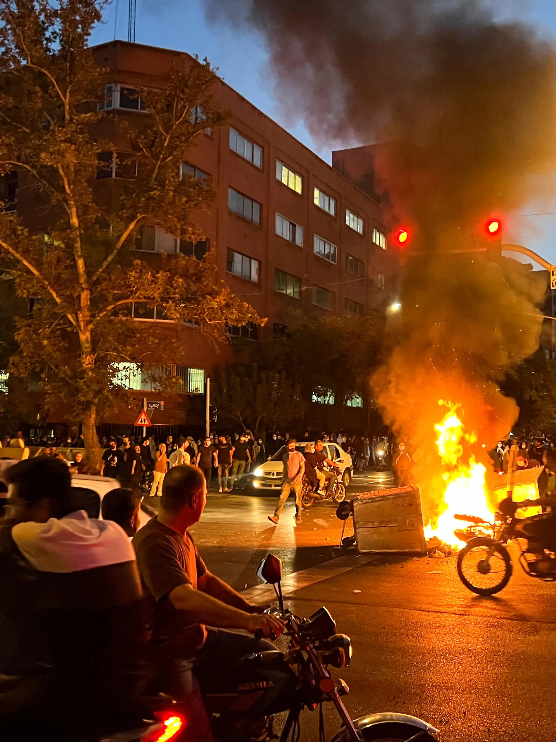 A police motorcycle burns during a protest over the death of Mahsa Amini, a woman who died after being arrested by the Islamic republic's "morality police", in Tehran, Iran September 19, 2022. WANA (West Asia News Agency) via REUTERS ATTENTION EDITORS - THIS IMAGE HAS BEEN SUPPLIED BY A THIRD PARTY.   ATTENTION EDITORS - THIS PICTURE WAS PROVIDED BY A THIRD PARTY