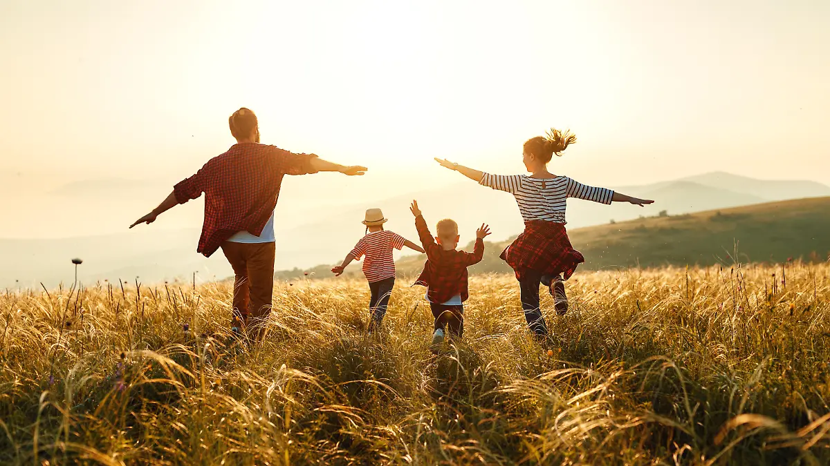 Happy family: mother, father, children son and  daughter on nature  on sunset