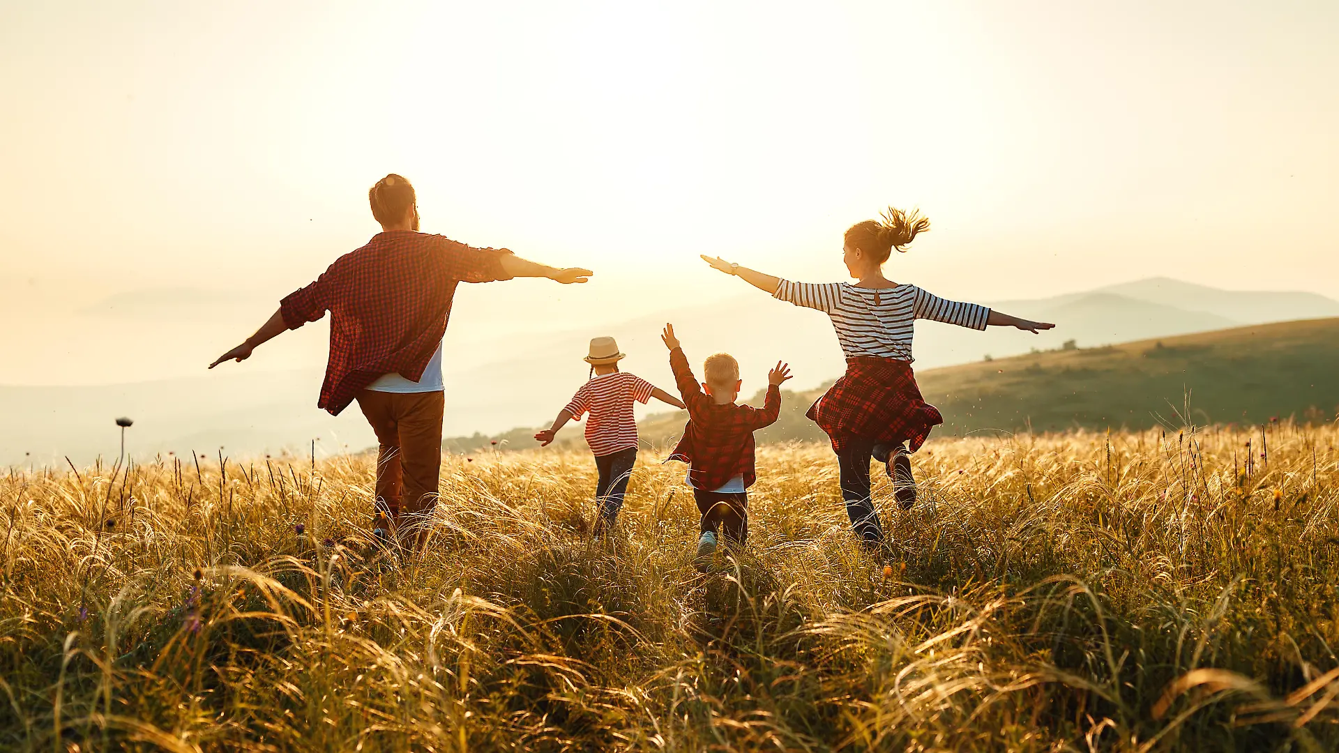 Happy family: mother, father, children son and daughter on nature on sunset