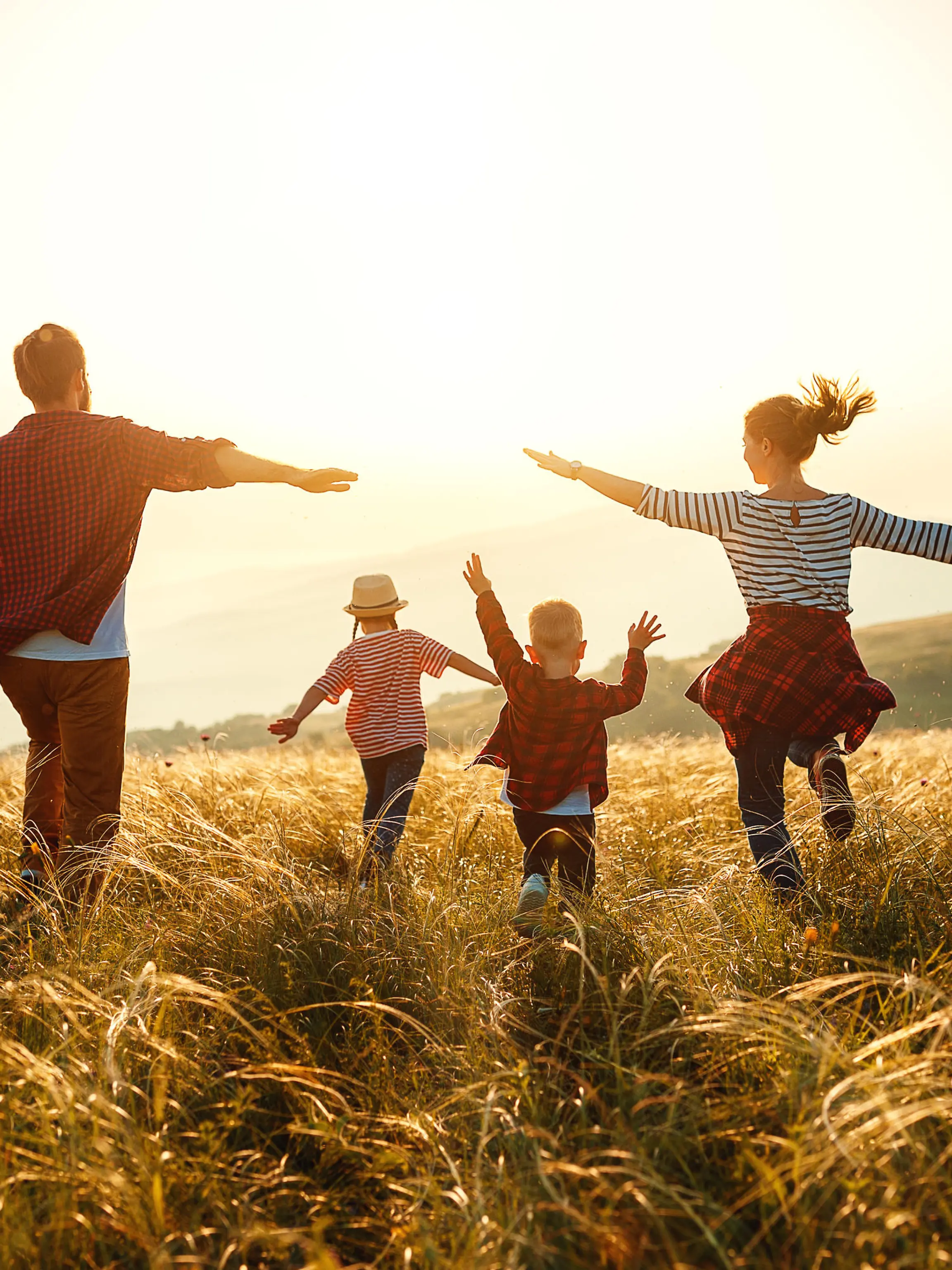 Happy family: mother, father, children son and daughter on nature on sunset