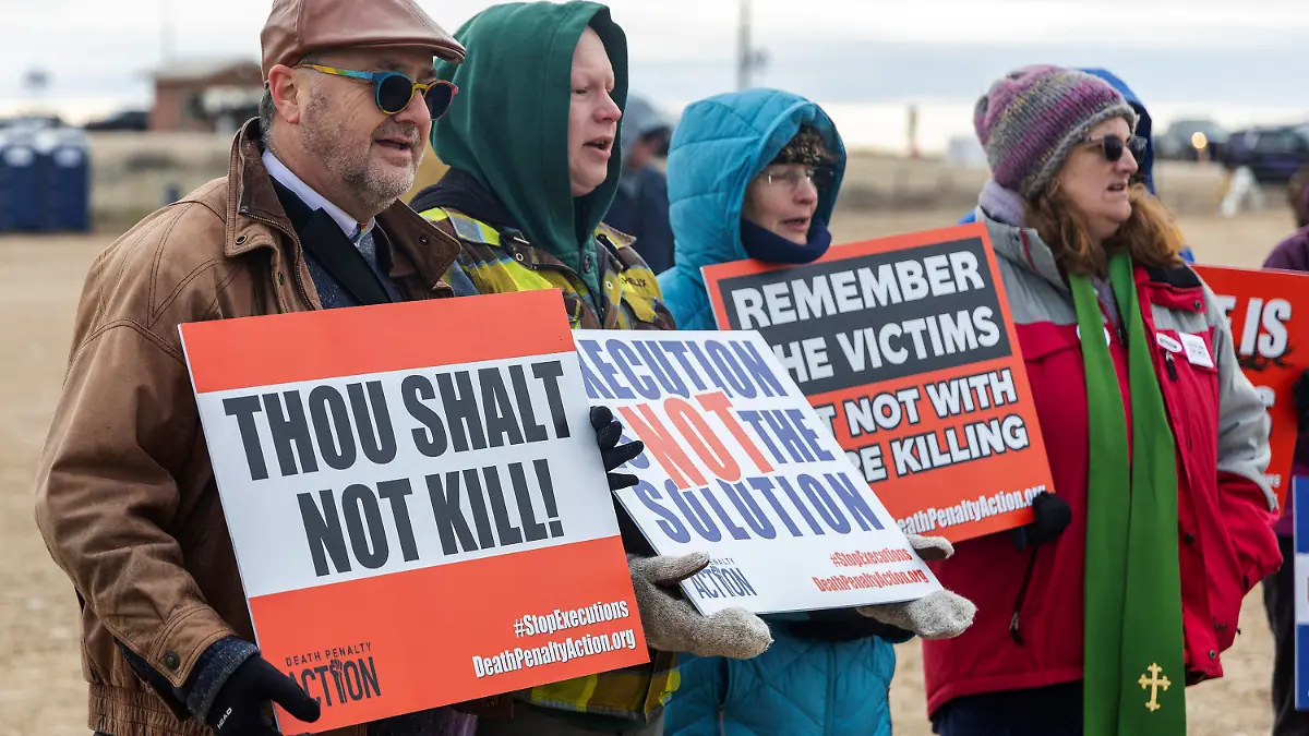 Pastor Duane Anders of Cathedral of the Rockies, left, and pastor Buddy Gharring of Hillview United Methodist, second from left, protest against the death penalty gathered outside of the Idaho State prison complex near Kuna, Idaho, Wednesday, Feb. 28, 2024. Idaho halted the execution of serial killer Thomas Eugene Creech on Wednesday after medical team members repeatedly failed to find a vein where they could establish an intravenous line to carry out the lethal injection. (Sarah A. Miller/Idaho Statesman via AP)