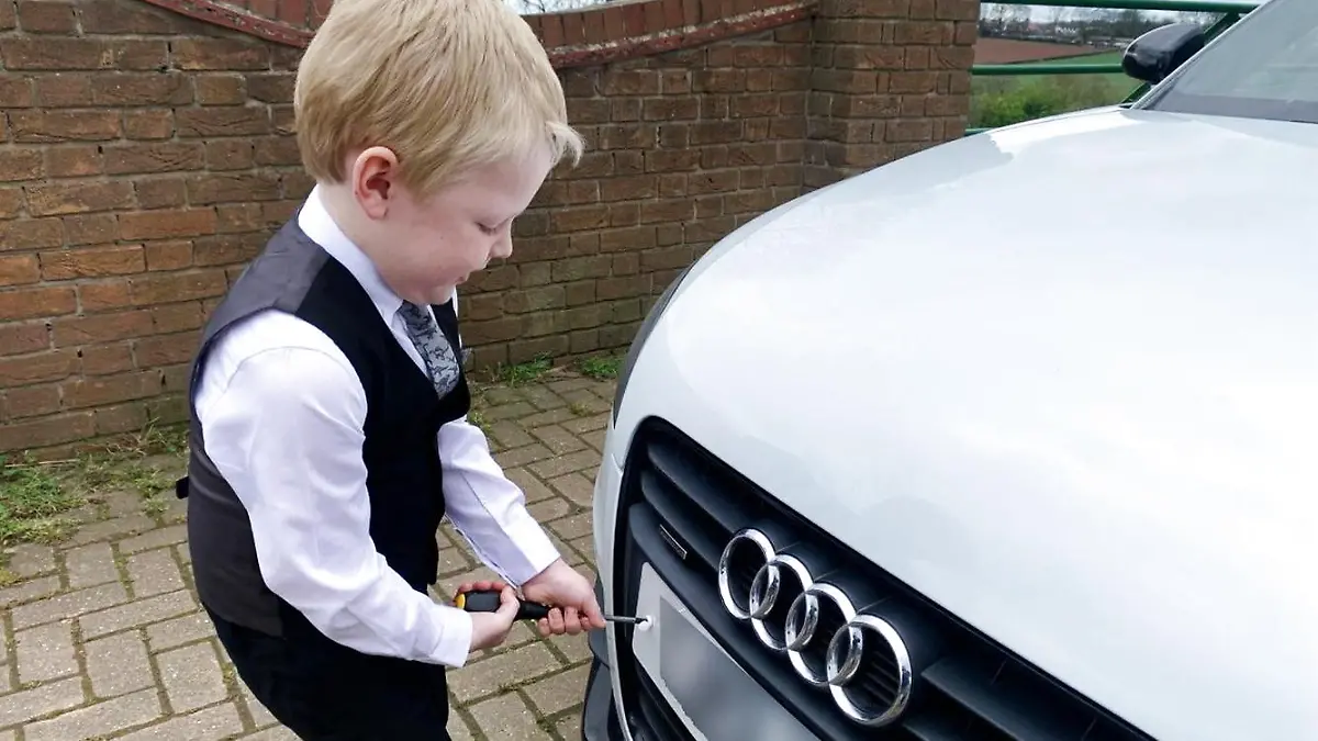 PIC FROM Kennedy News and Media (PICTURED: ALFIE WARD (5) FROM WORKSOP, NOTTINGHAMSHIRE, WHO HELPS HIS DAD AT WORK AT HIS CAR DEALERSHIP) This five-year-old lad has been working alongside his dad at their car dealership since the age of ONE - earning £1 for every scratch or dent he spots. Matt Ward said that he's been bringing his son Alfie Ward to work at his used car dealership Voldi Ltd every Saturday 'come rain, sleet, sun, snow or shine' for the past three and a half years. But when the 37-year-old was quizzed by one customer why Alfie was not 'inside watching TV', Matt was comepelled to outlined the benefits for his son including increasing his self-esteem, enabling him to learn the value of money and creating 'fun memories' with his dad. DISCLAIMER: While Kennedy News and Media uses its best endeavours to establish the copyright and authenticity of all pictures supplied, it accepts no liability for any damage, loss or legal action caused by the use of images supplied and the publication of images is solely at your discretion. SEE KENNEDY NEWS COPY - 0161 697 4266