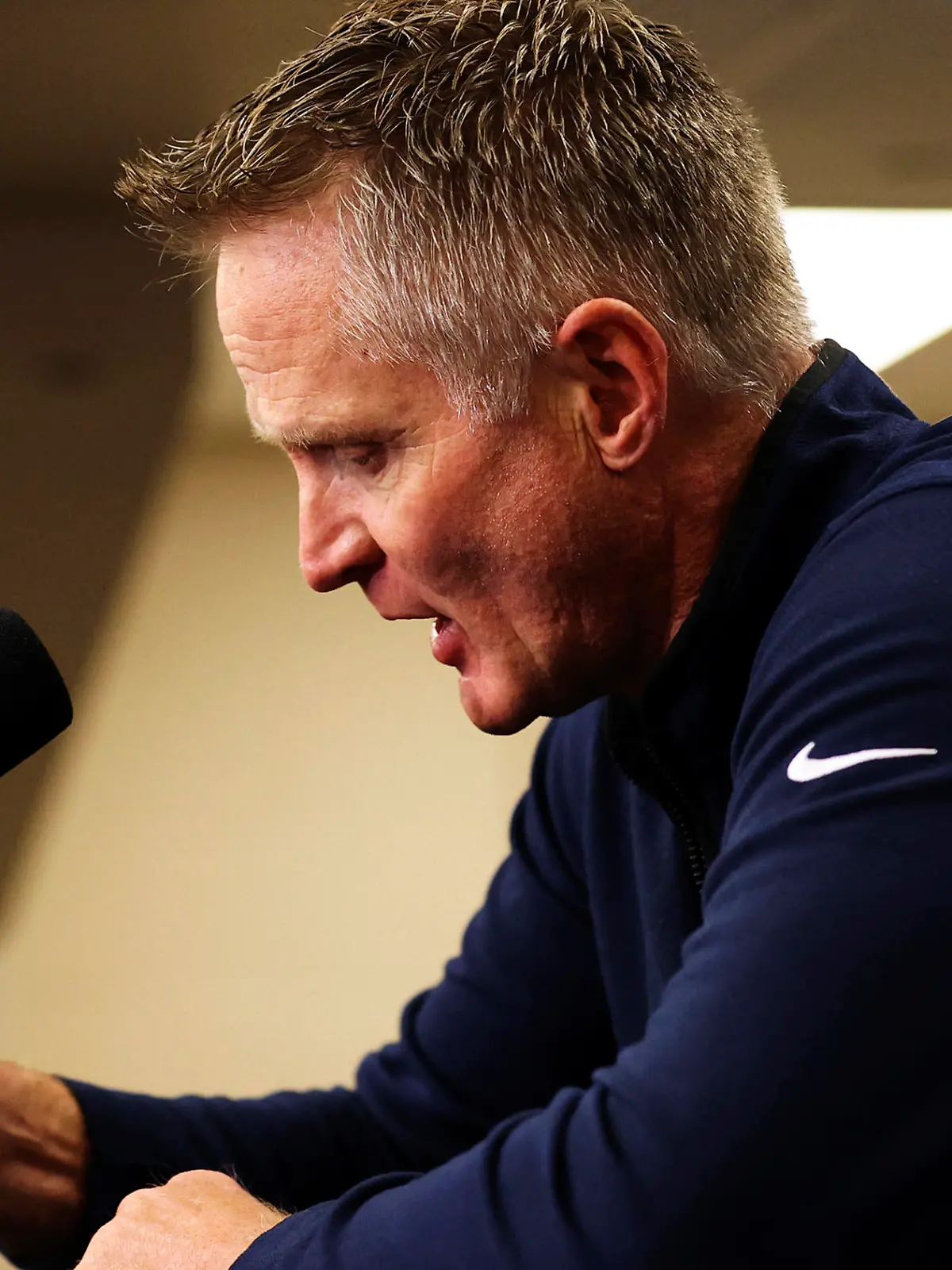 Reacting to the Uvalde, Texas, school shooting earlier in the day, Golden State Warriors coach Steve Kerr bangs his fist on the table as he makes a statement before Warriors played the Dallas Mavericks in Game 4 of the NBA basketball playoffs Western Conference finals Tuesday, May 24, 2022, in Dallas. (Scott Strazzante/San Francisco Chronicle via AP)