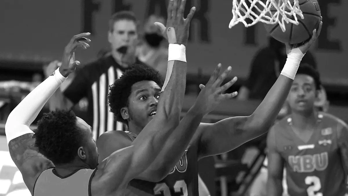FILE - Houston Baptist guard Darius Lee (23) jumps for a layup during the first half of an NCAA college basketball game against Arizona State, Nov. 29, 2020, in Tempe, Ariz. Lee was killed and eight other people were wounded Monday, June 20, 2022 in an early-morning shooting at a gathering in Harlem, New York City police said. (AP Photo/Rick Scuteri, file)