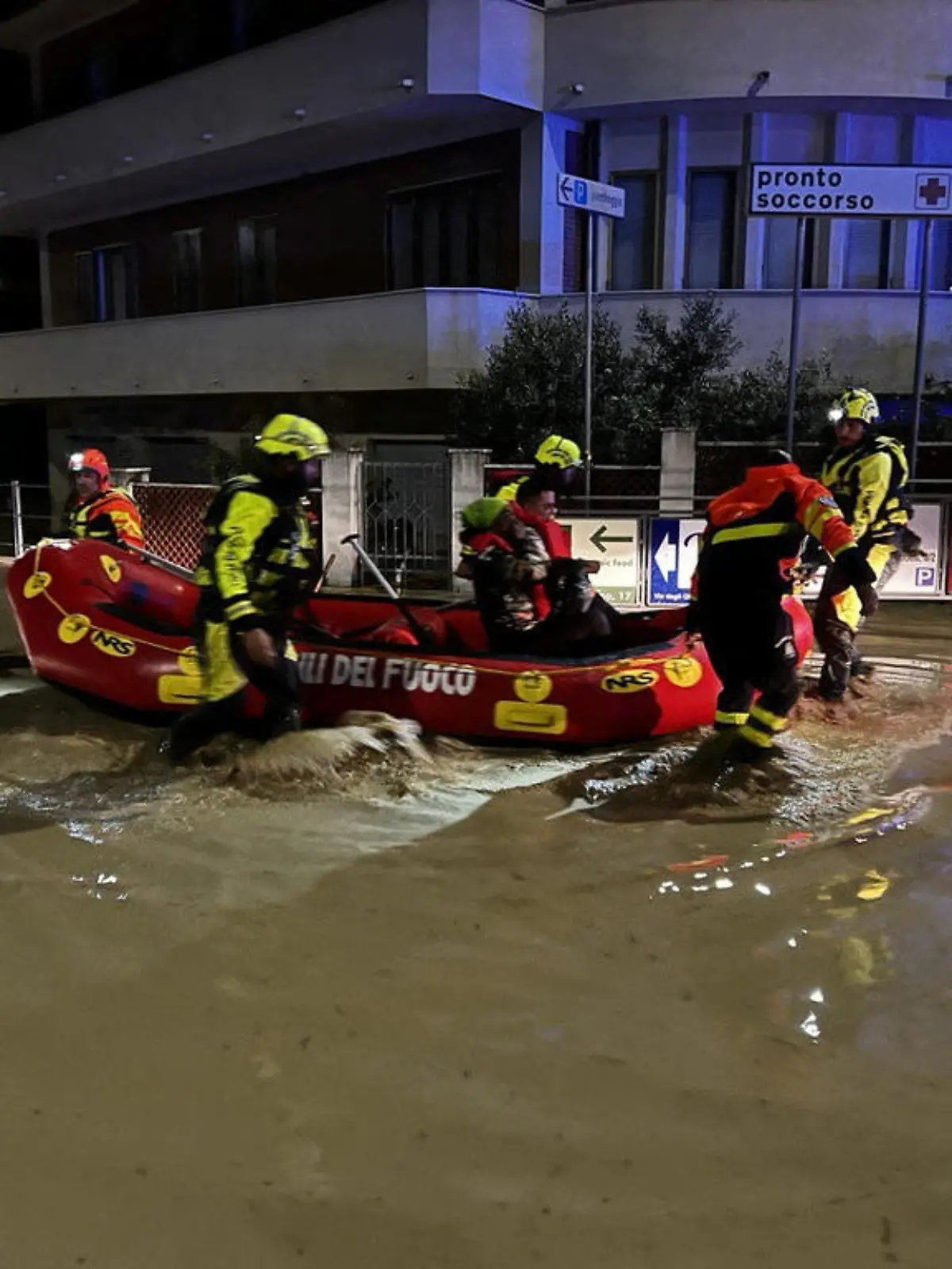 Rescue workers rescue people on a dinghy boat on a flooded street after heavy rains hit the east coast of Marche region in Senigallia, Italy, September 16, 2022. Vigili del Fuoco/Handout via REUTERS ATTENTION EDITORS THIS IMAGE HAS BEEN SUPPLIED BY A THIRD PARTY. DO NOT OBSCURE LOGO.