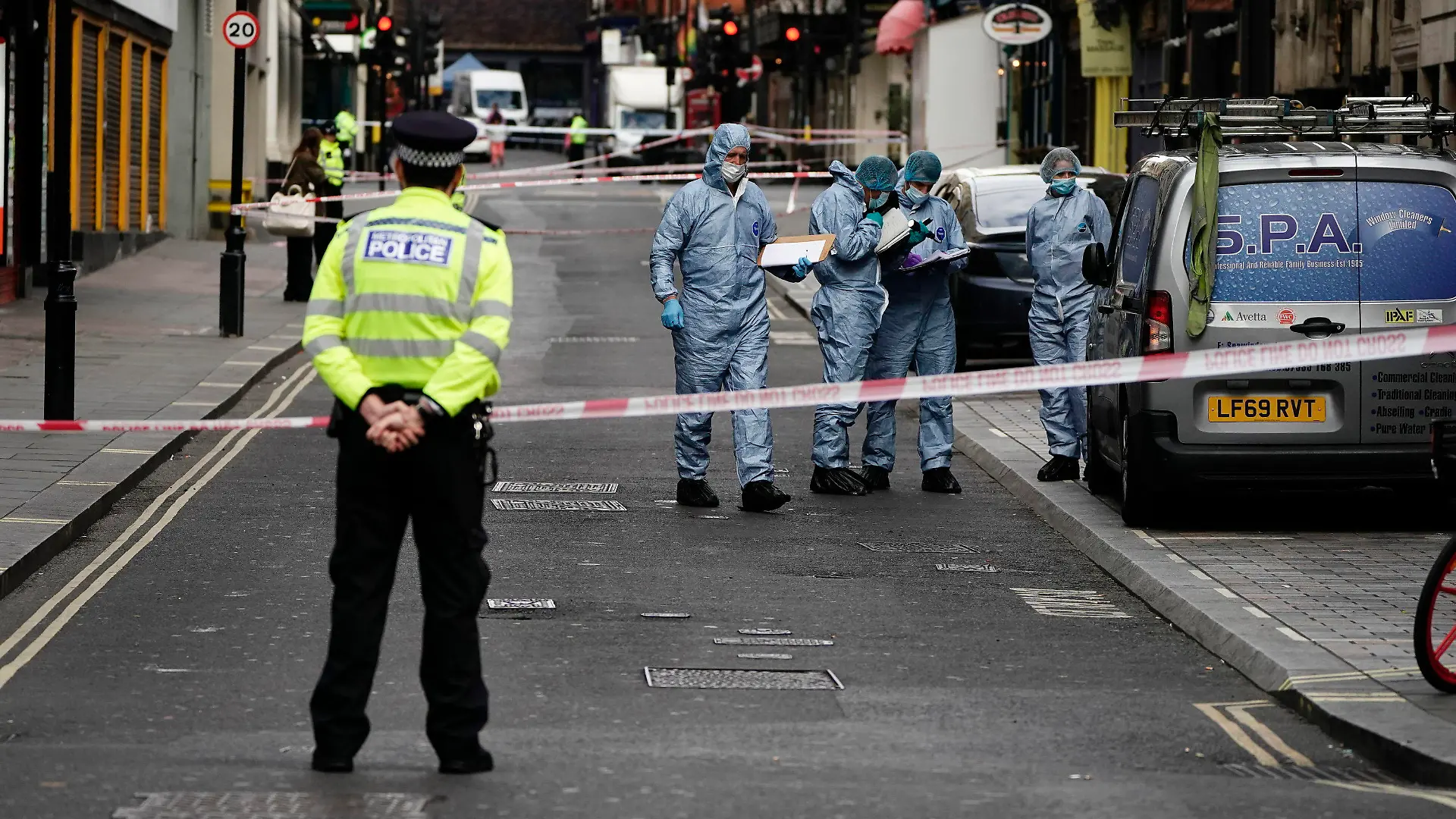 Forensics officers and police at the scene in Shaftesbury Avenue, where two male police officers were stabbed, in London, Friday, Sept. 16, 2022. London’s police force says two officers have been hospitalized after being stabbed in central London early Friday. It says the attack is not being treated as terrorism. The Metropolitan Police force says officers “encountered a man with a knife” in the Leicester Square area, a busy tourist hub, at around 6 a.m. (Aaron Chow/PA via AP)