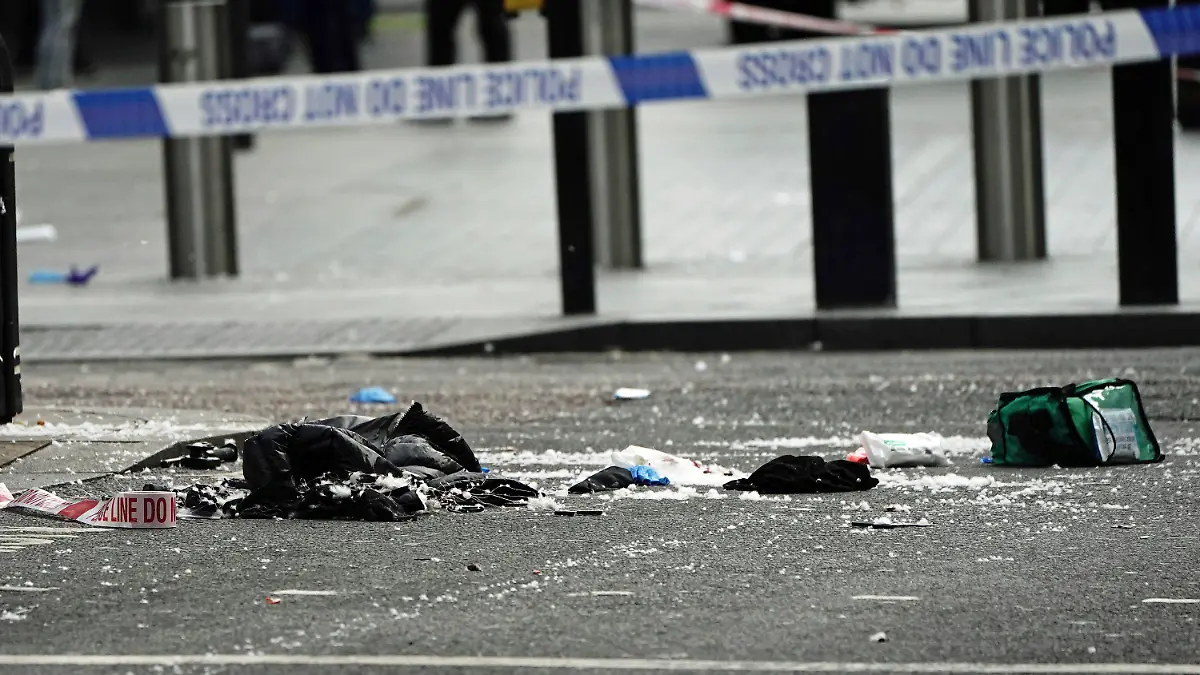 Items in the street  at the scene in Shaftesbury Avenue, where two male police officers were stabbed, in London, Friday, Sept. 16, 2022.  London’s police force says two officers have been hospitalized after being stabbed in central London early Friday. It says the attack is not being treated as terrorism. The Metropolitan Police force says officers “encountered a man with a knife” in the Leicester Square area, a busy tourist hub, at around 6 a.m. (Aaron Chow/PA via AP)