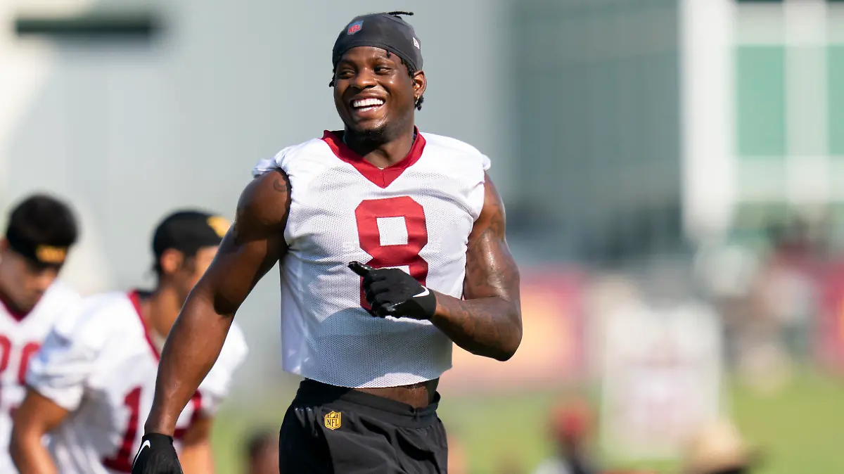 Washington Commanders running back Brian Robinson Jr. laughs while warming up during an NFL football practice at the team's training facility, Friday, July 28, 2023, in Ashburn, Va. (AP Photo/Stephanie Scarbrough)