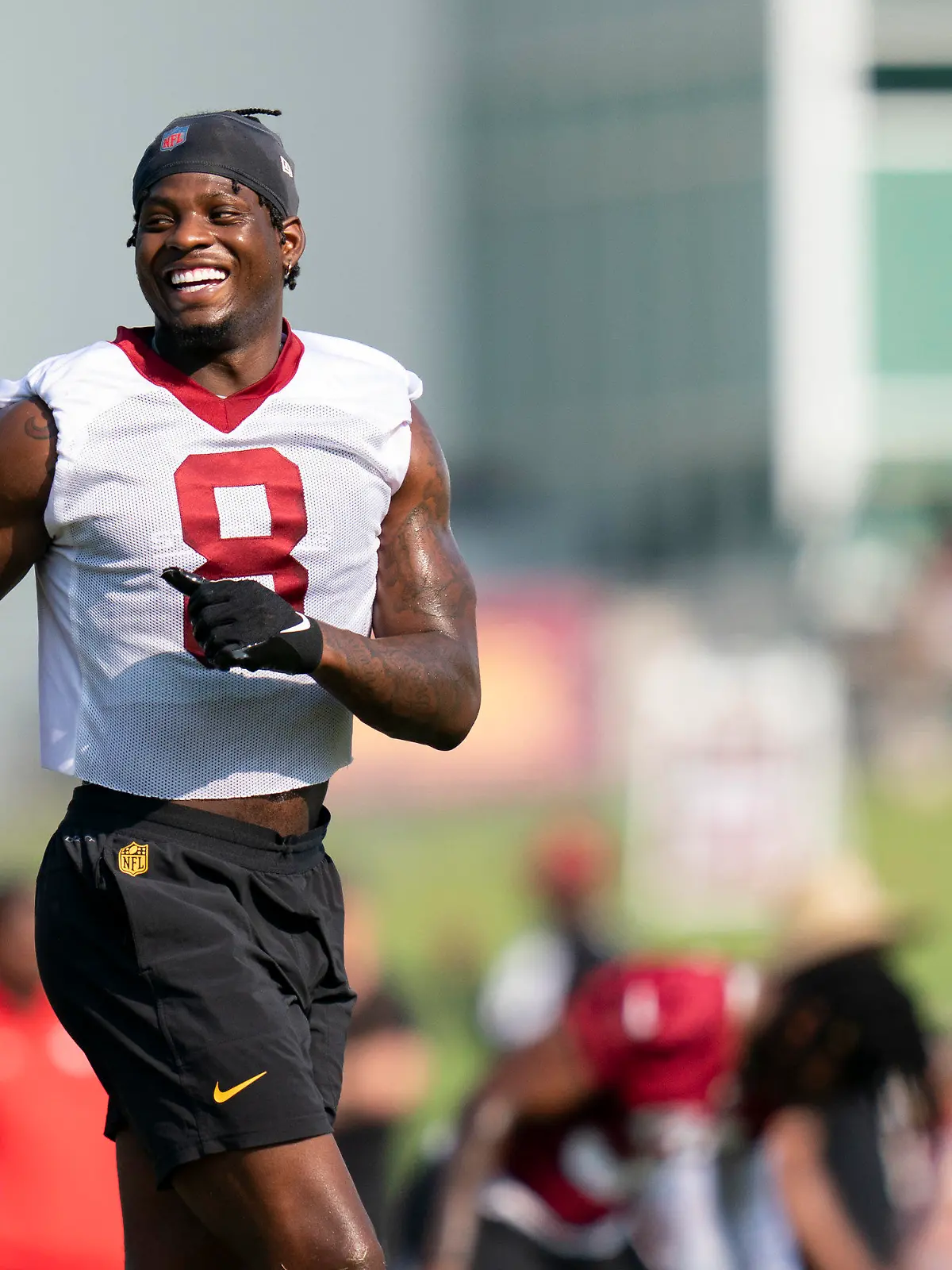 Washington Commanders running back Brian Robinson Jr. laughs while warming up during an NFL football practice at the team's training facility, Friday, July 28, 2023, in Ashburn, Va. (AP Photo/Stephanie Scarbrough)