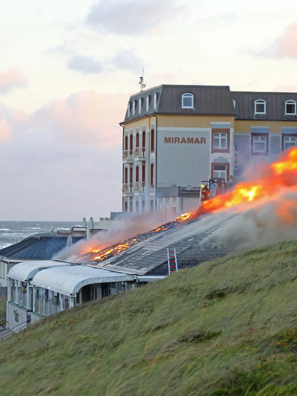 15.09.2022, Schleswig-Holstein, Westerland: Feuerwehrleute im Einsatz bei der Bekämpfung eines Brands auf Sylt.       (zu dpa «Restaurant auf Promenade in Westerland niedergebrannt») Foto: Georg Supanz/dpa +++ dpa-Bildfunk +++