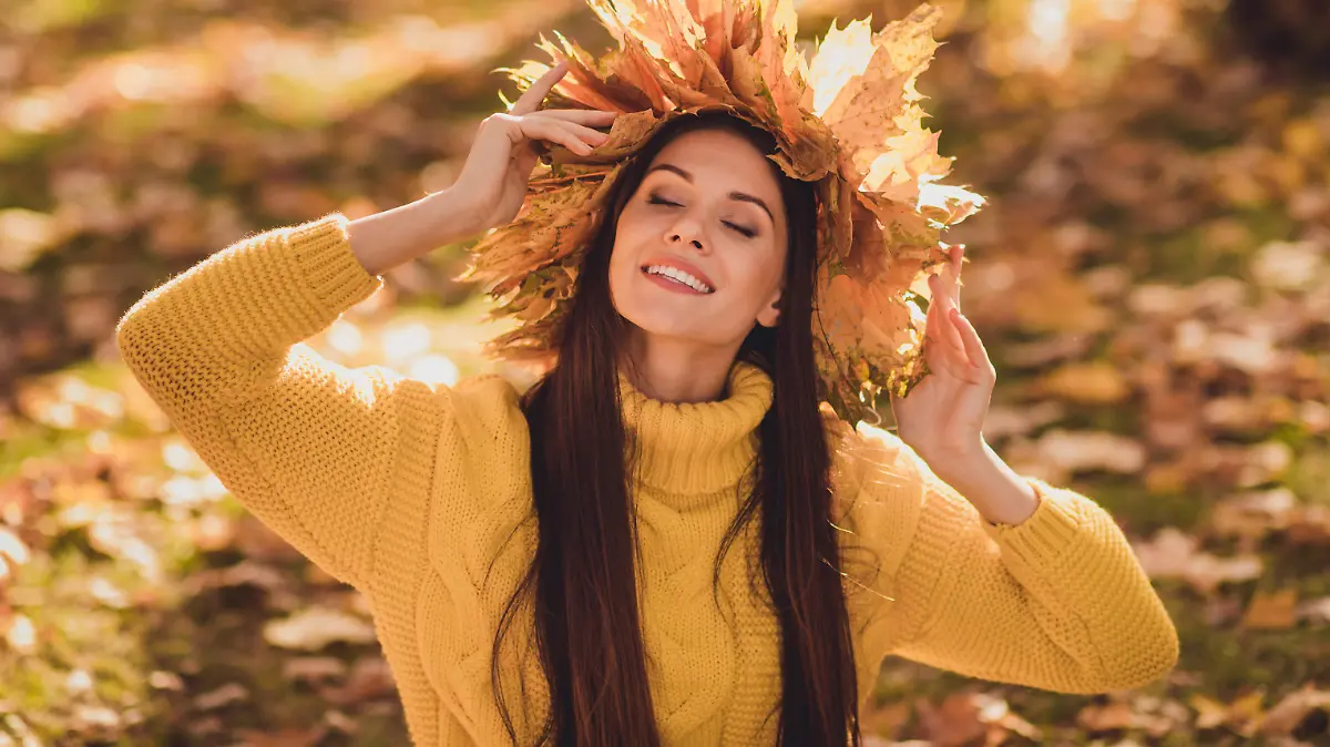Portrait of positive cheerful girl have autumn forest woodland grove picnic enjoy, sun light wear maple leaves wreath knitted sweater pullover