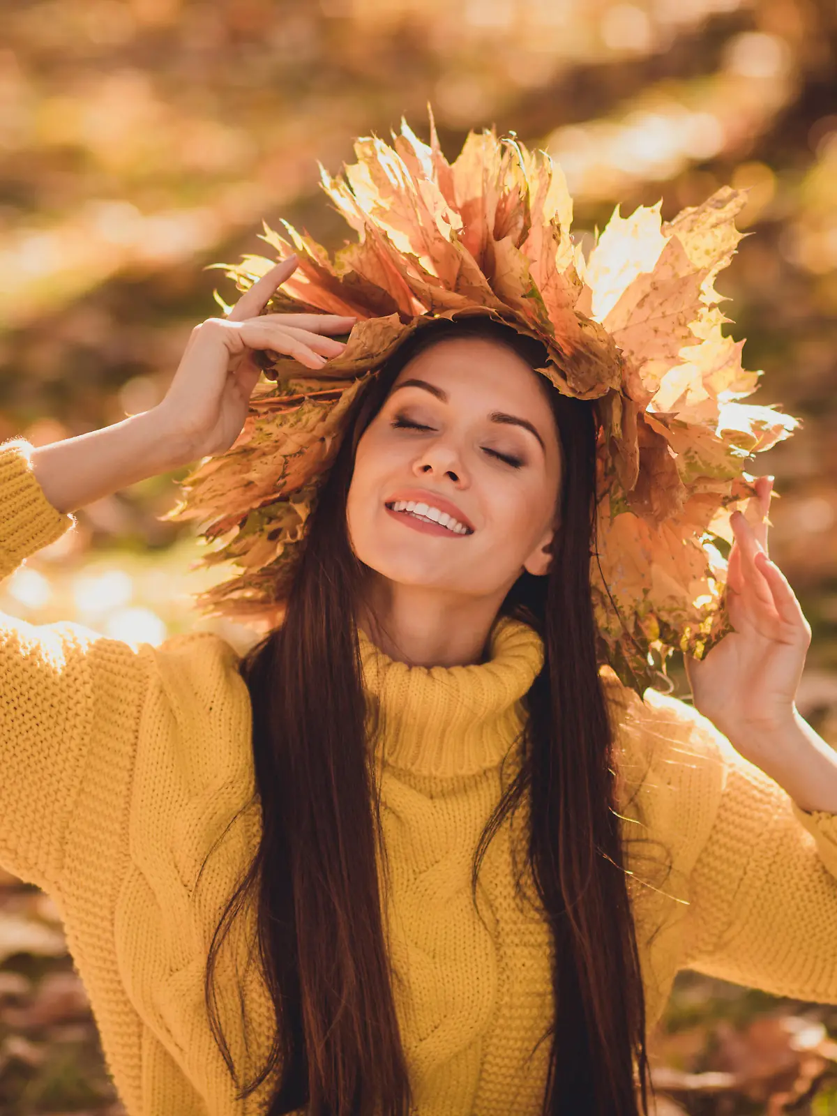 Portrait of positive cheerful girl have autumn forest woodland grove picnic enjoy, sun light wear maple leaves wreath knitted sweater pullover