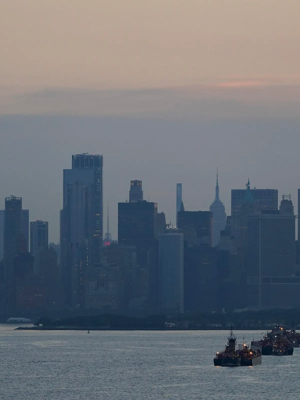 FILE - The New York City skyline is seen from New York Harbor in New York, Wednesday, June 30, 2021.  On Friday, Aug. 19, 2022, The Associated Press reported on stories circulating online incorrectly claiming Polio has been found in New York City tap water.(AP Photo/Seth Wenig, File)