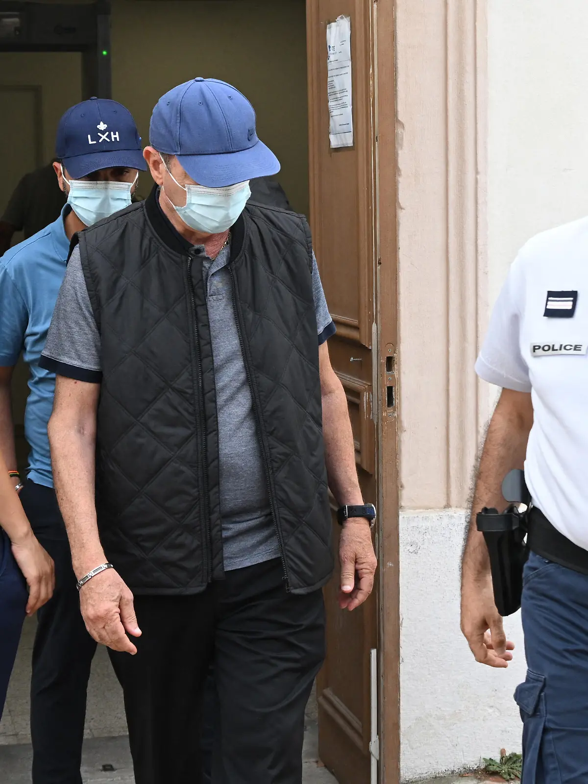 French ex-dentists Lionel (back) and his father Carnot Guedj (2nd R), accused of fraud and dental mutilation arrive at the courthouse on the trial voting and sentencing's day in Marseille, southern France, on September 8, 2022. - Lionel Guedj was sentenced on September 8, 2022 in Marseille to eight years in prison with an immediate committal order for having mutilated hundreds of patients, while enriching himself on the Social Security and mutual insurance companies. (Photo by Christophe SIMON / AFP) (Photo by CHRISTOPHE SIMON/AFP via Getty Images)