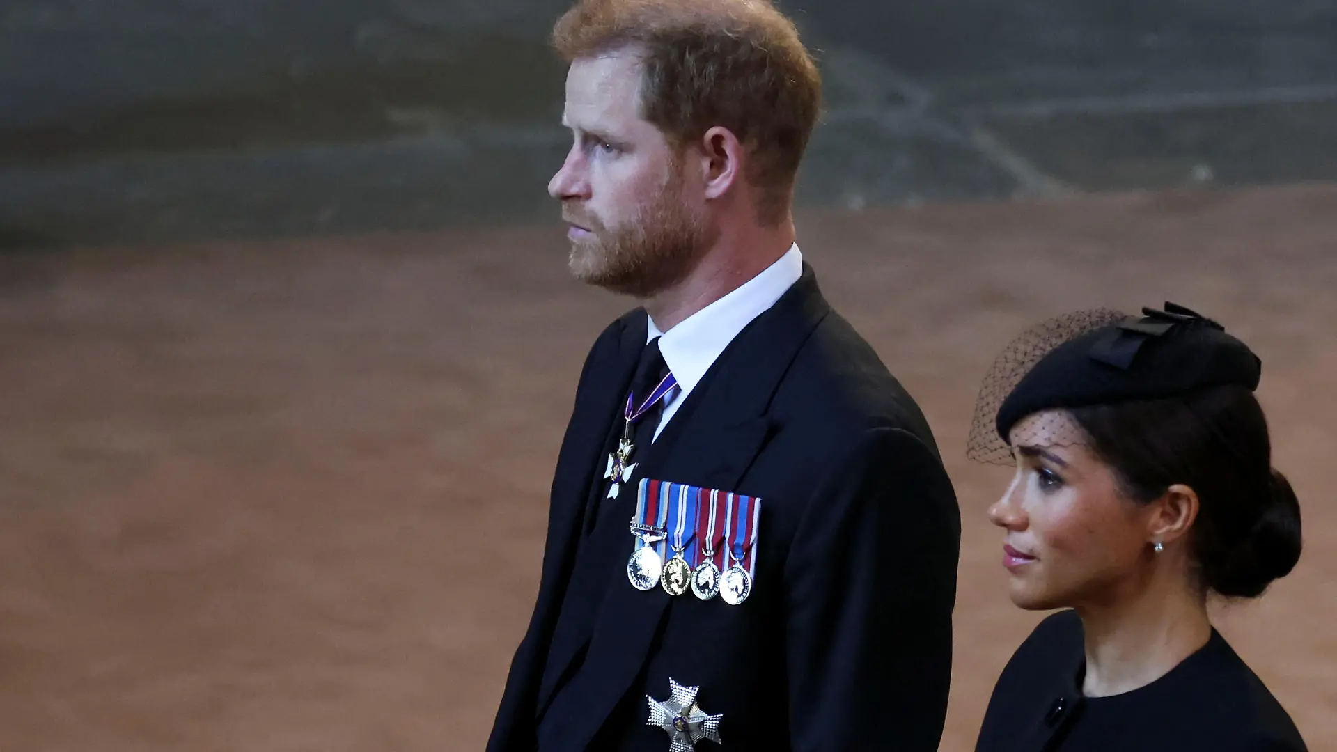 Britain's Prince Harry and Meghan, Duchess of Sussex walk as procession with the coffin of Britain's Queen Elizabeth arrives at Westminster Hall from Buckingham Palace for her lying in state, in London, Britain, September 14, 2022.  REUTERS/Phil Noble/Pool
