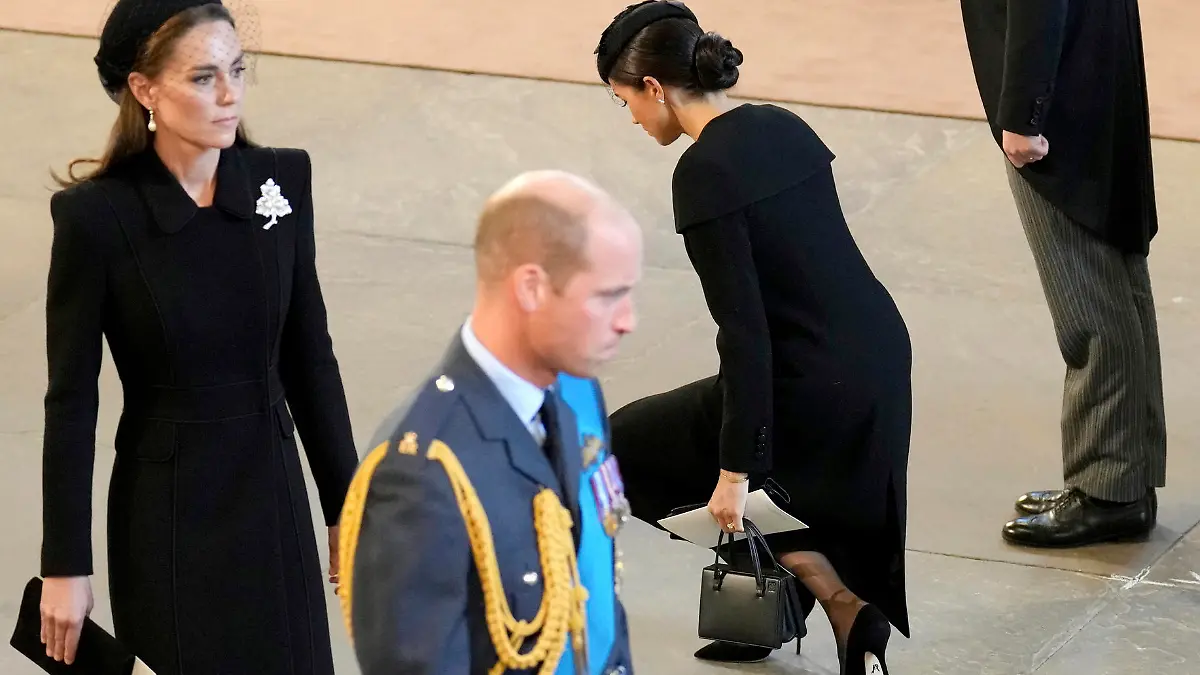 Britain's Prince William, foreground, Kate, Princess of Wales, left, Prince Harry, right, and his wife Meghan, the Duchess of Sussex, pay their respects to Queen Elizabeth II as the coffin rests in Westminster Hall for her Lying-in State, in London, Wednesday, Sept. 14, 2022. (Christopher Furlong/Pool Photo via AP)