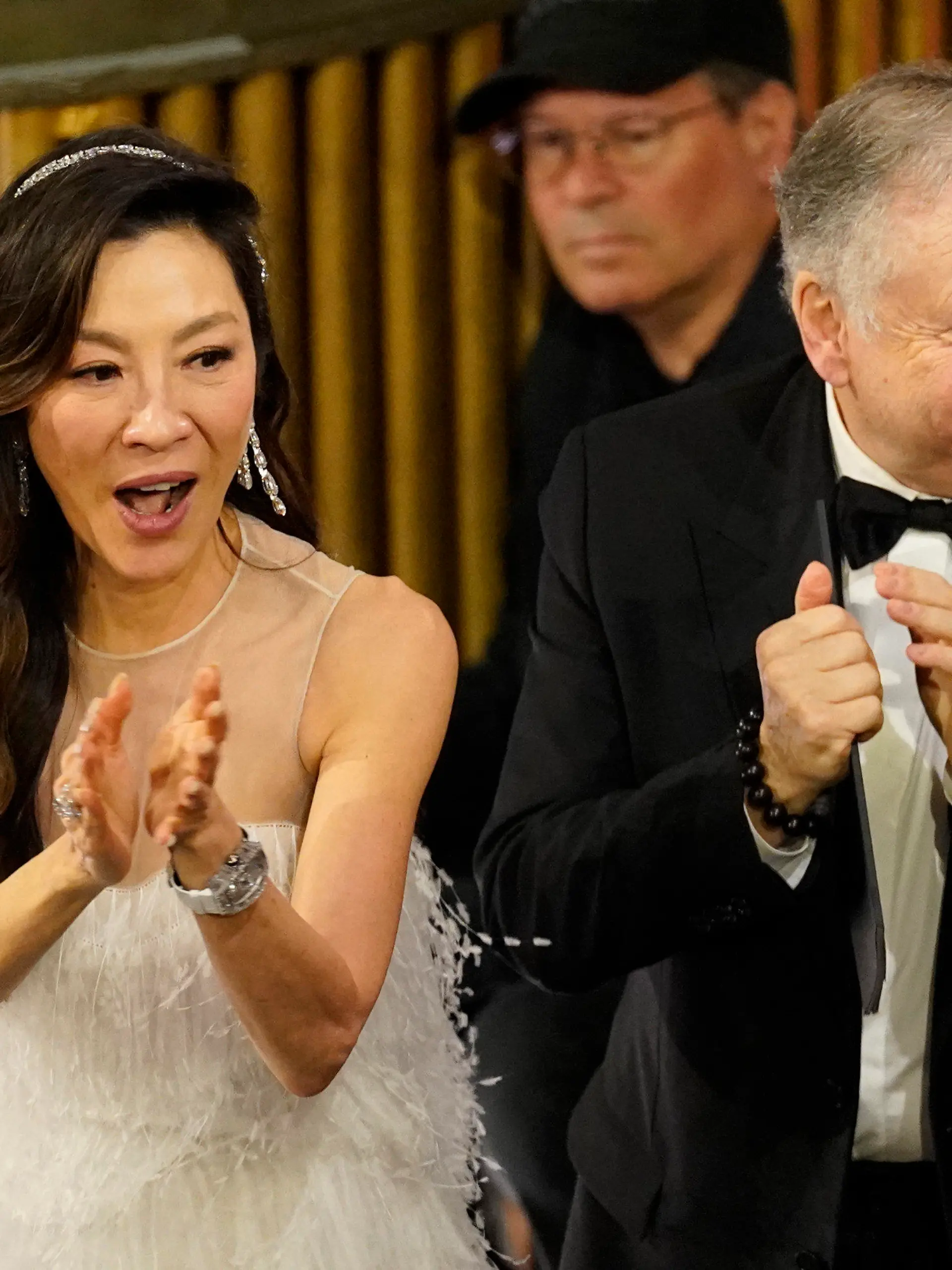 Michelle Yeoh, left, and Jean Todt, cheer in the audience at the Oscars on Sunday, March 12, 2023, at the Dolby Theatre in Los Angeles. (AP Photo/Chris Pizzello)