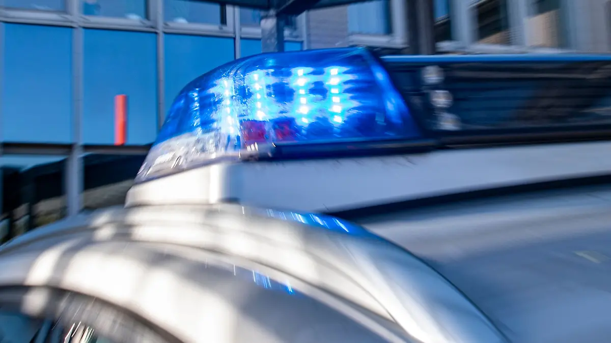 Ein Blaulicht leuchtet auf dem Dach eines Polizeiwagens.