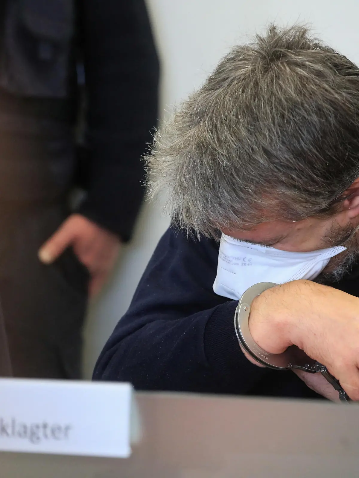 Defendant, the 50-year-old man who is accused of having killed a 20-year-old gas station attendant, on September 18, 2021, in Idar-Oberstein, who had asked him to wear the compulsory protective mask against the spread of the coronavirus disease (COVID-19), wears a face mask at a local court in Bad Kreuznach, Germany, March 21, 2022.   REUTERS/Wolfgang Rattay