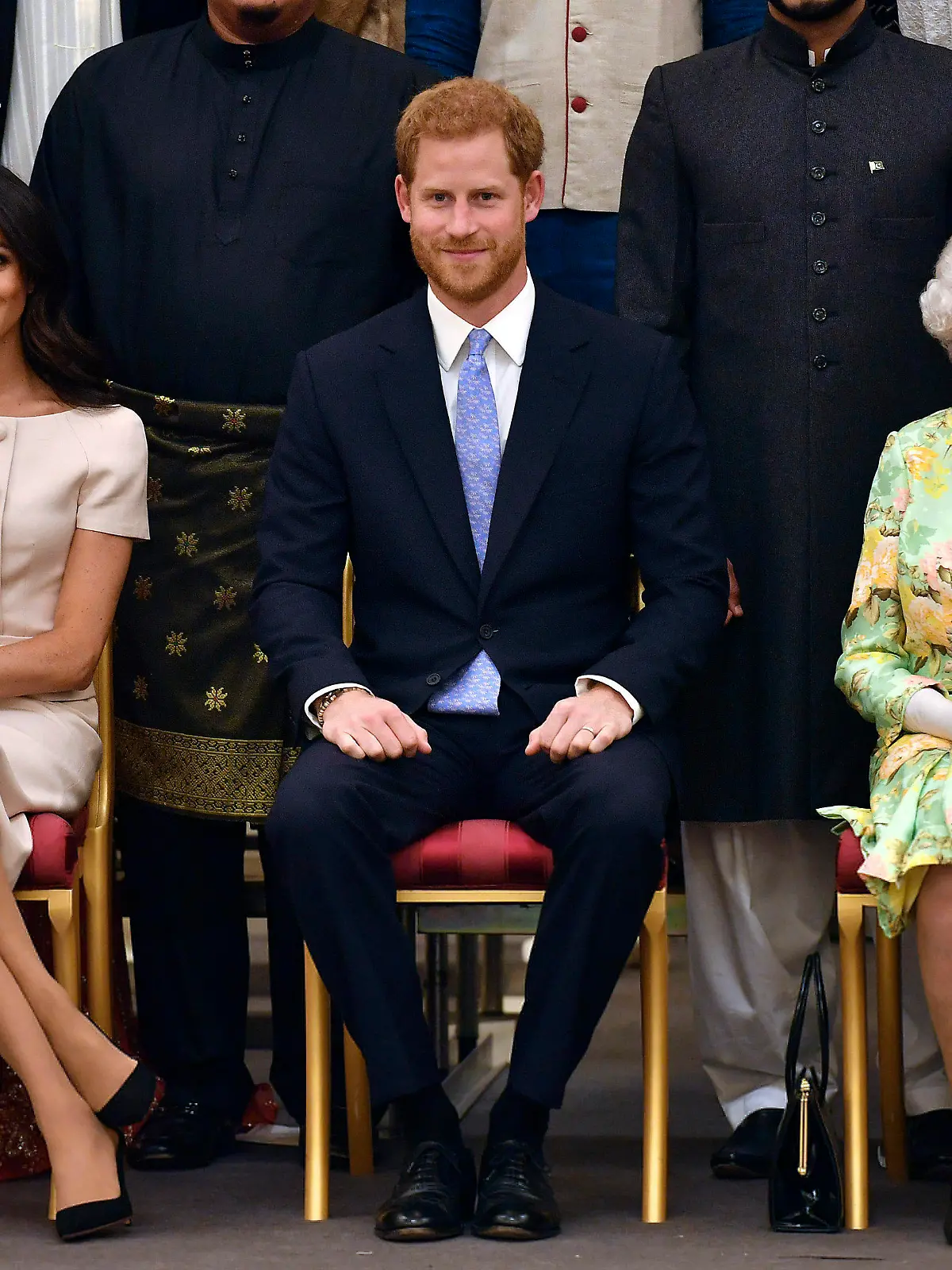 FILE - In this Tuesday, June 26, 2018 file photo, Britain's Queen Elizabeth, Prince Harry and Meghan, Duchess of Sussex pose for a group photo at the Queen's Young Leaders Awards Ceremony at Buckingham Palace in London. Queen Elizabeth II, Britain’s longest-reigning monarch and a rock of stability across much of a turbulent century, has died. She was 96. Buckingham Palace made the announcement in a statement on Thursday Sept. 8, 2022.(John Stillwell/Pool Photo via AP, File)