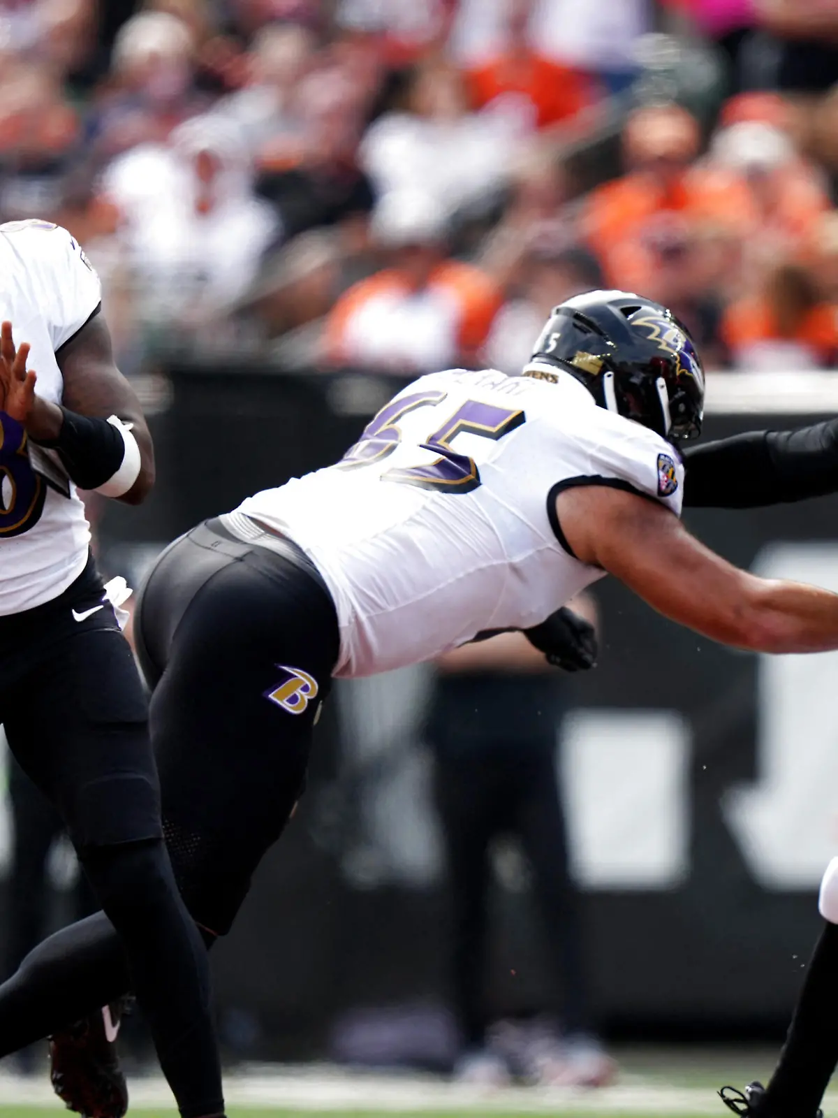 Sep 17, 2023; Cincinnati, Ohio, USA; Baltimore Ravens quarterback Lamar Jackson (8) throws as Cincinnati Bengals defensive end Trey Hendrickson (91) applies pressure while Ravens guard Patrick Mekari (65) blocks in the first quarter at Paycor Stadium. Mandatory Credit: Albert Cesare-USA TODAY Sports