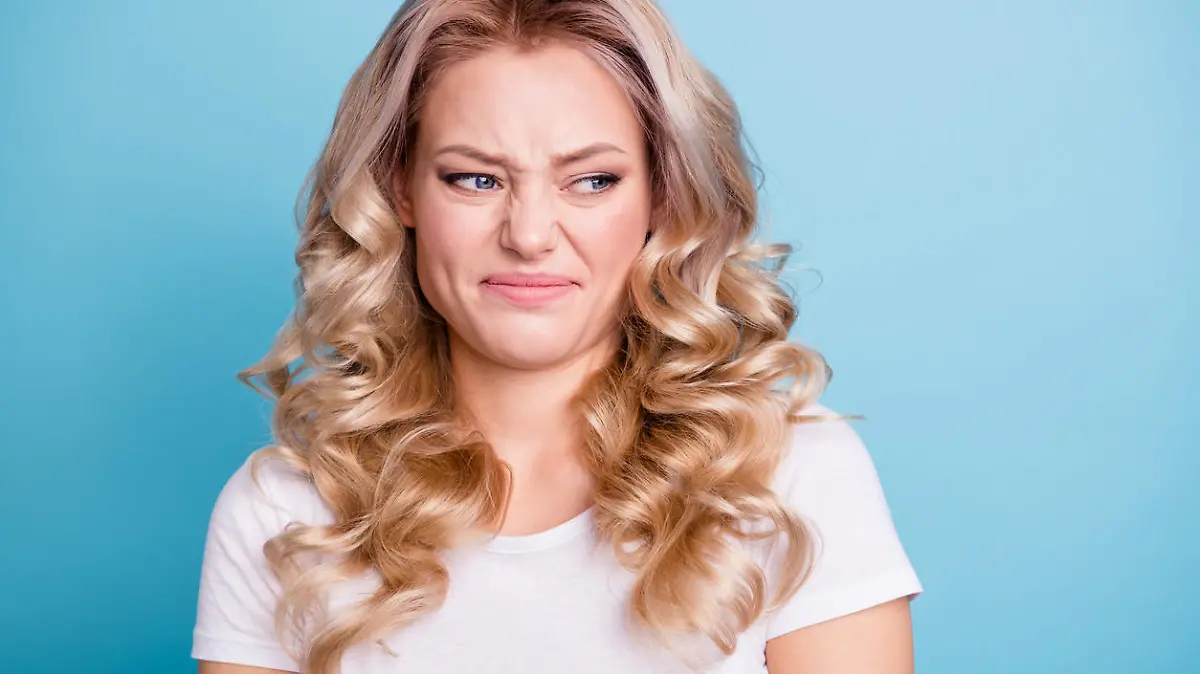 Close up photo beautiful her she lady awful awkward situation look hate mad rage outraged ugh facial expression wear casual white t-shirt jeans denim clothes outfit isolated bright blue background.